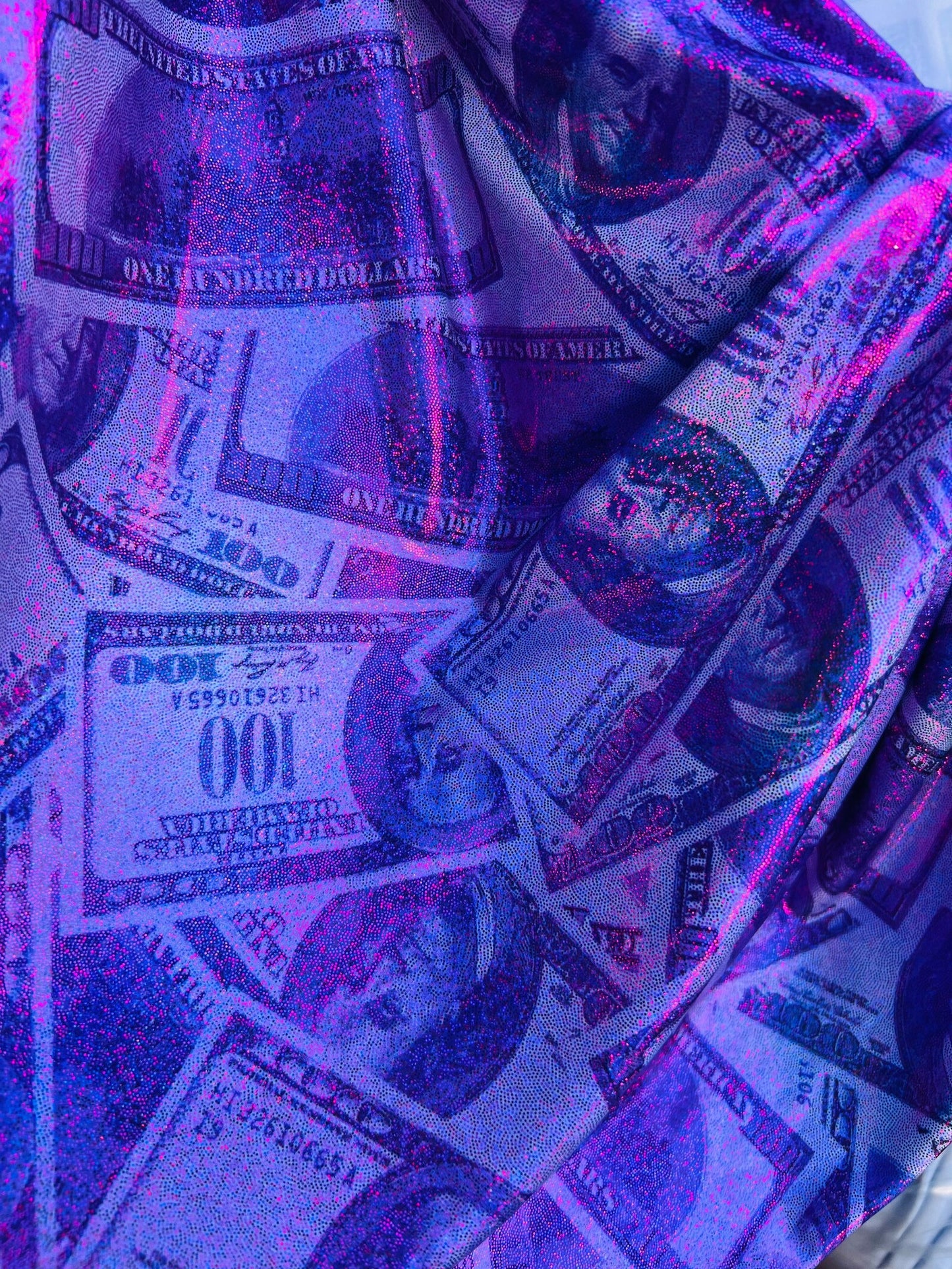 New metallic heavy nylon spandex money design 100 dollar bill print on 4-way spandex with foggy foil all over 58/60” Sold by the YD.