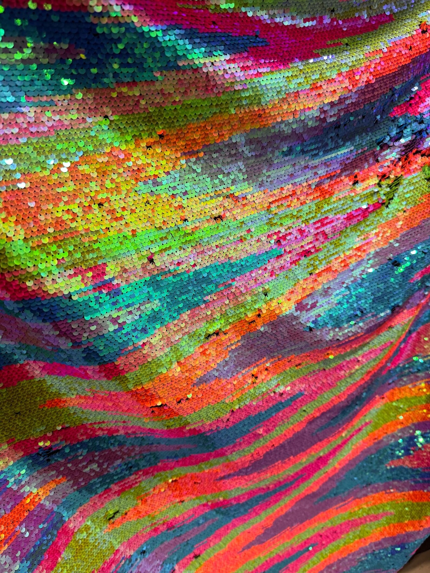 Zig Zag abstract design Rainbow sequins on spandex base 2-way stretch 58/60” Sold by the YD.