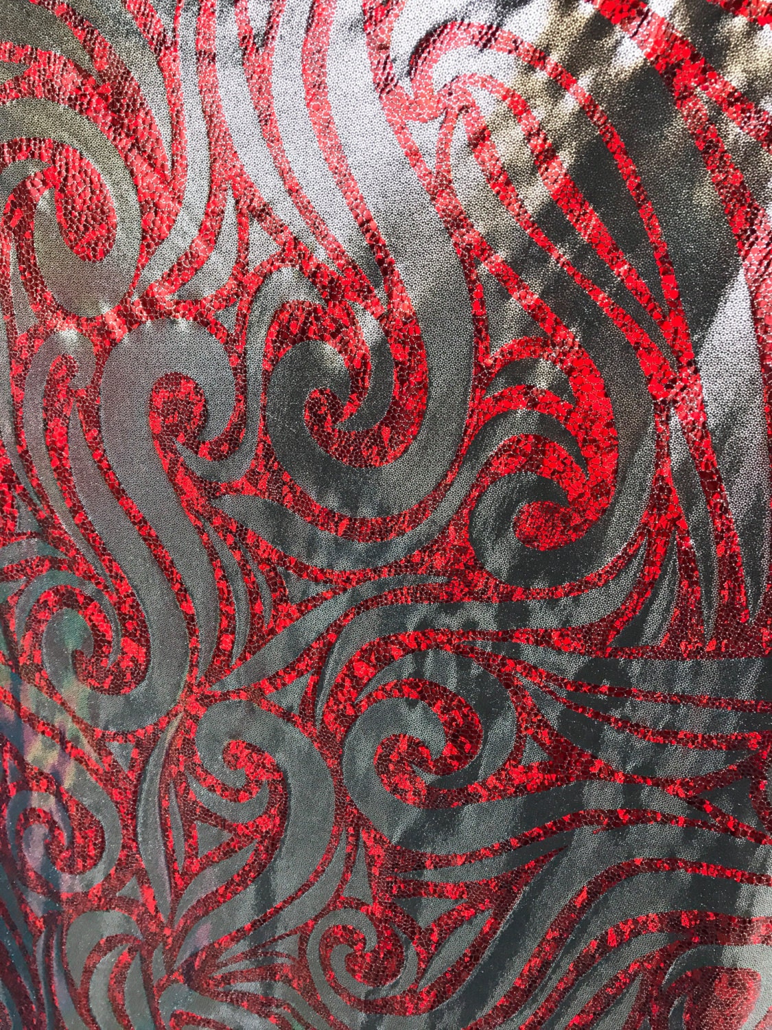 Metallic spandex with swirl hologram foil design 58/60" sold by the yd. Ships worldwide from Los Angeles CA United States.