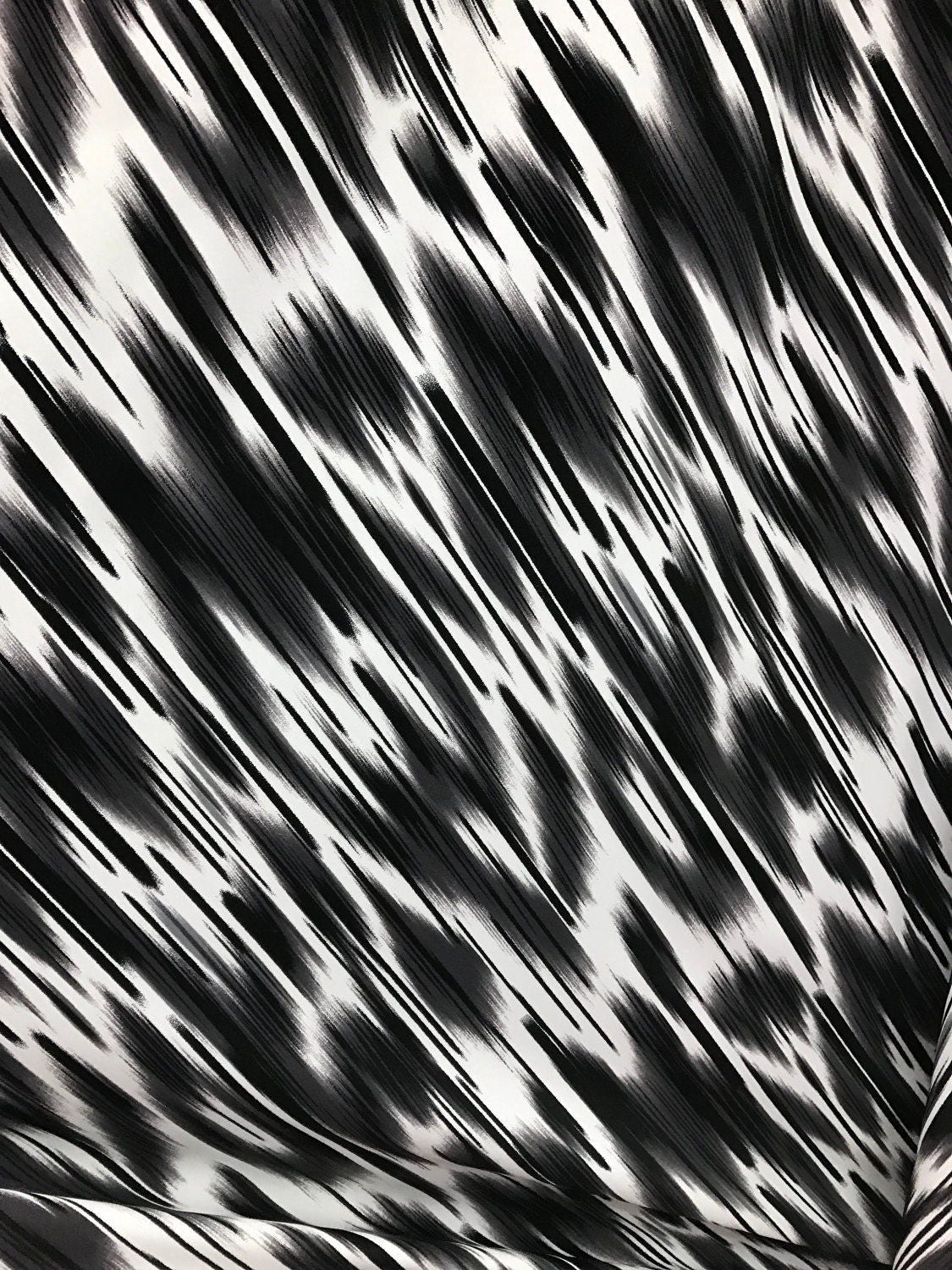 Abstract designs black/white print on nylon spandex 4way Stretch 58/60" Sold by the YD. Ships worldwide from Los Ángeles California USA.