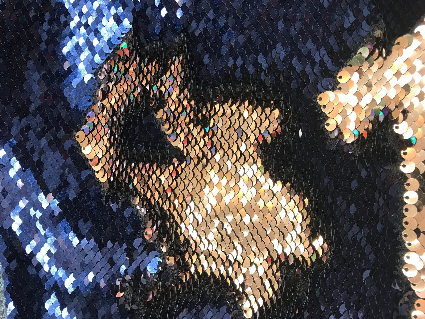 New flip up sequins Navy/bronce on spandex base2 way stretch 58/60" Sold by the YD. Ships worldwide from Los Angeles California.