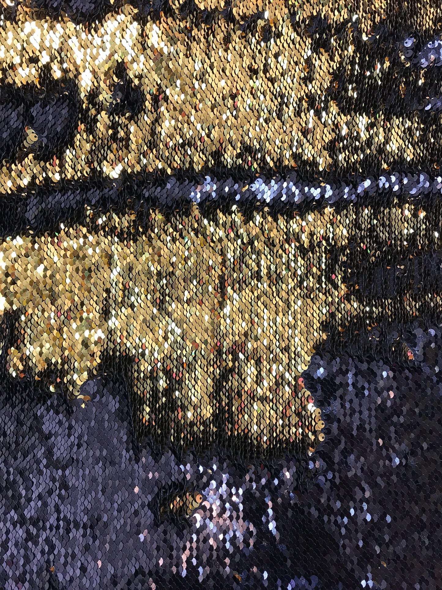 Black/gold flip up sequins reversible sequins on spandex base 2way stretch 58/60" Sold by the YD. Ships worldwide from Los Angeles CA USA.