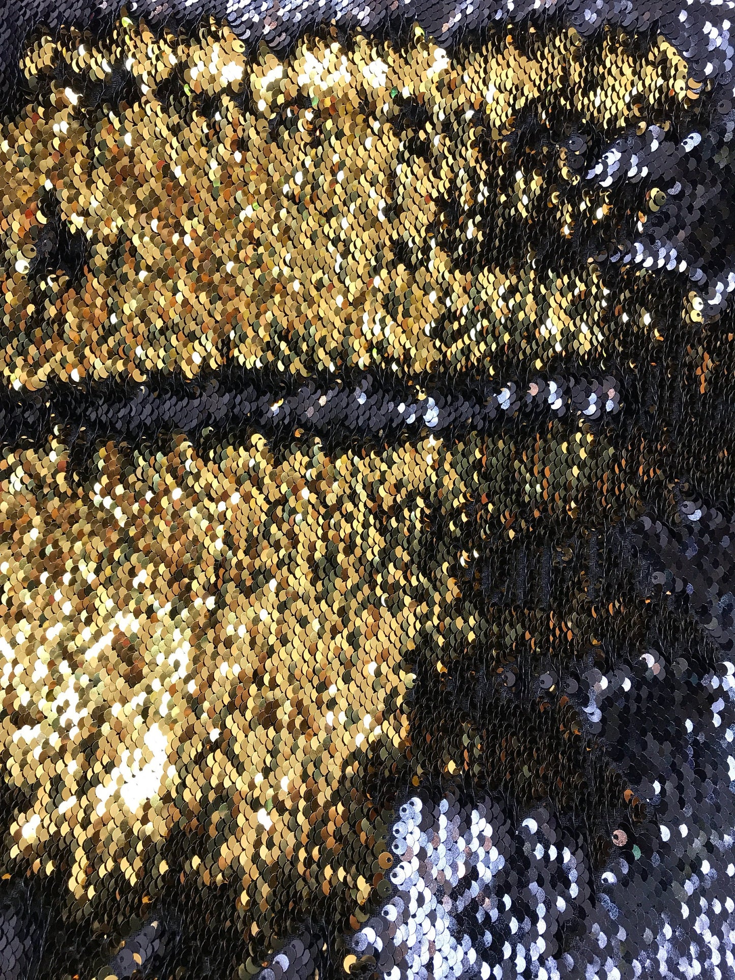 Black/gold flip up sequins reversible sequins on spandex base 2way stretch 58/60" Sold by the YD. Ships worldwide from Los Angeles CA USA.