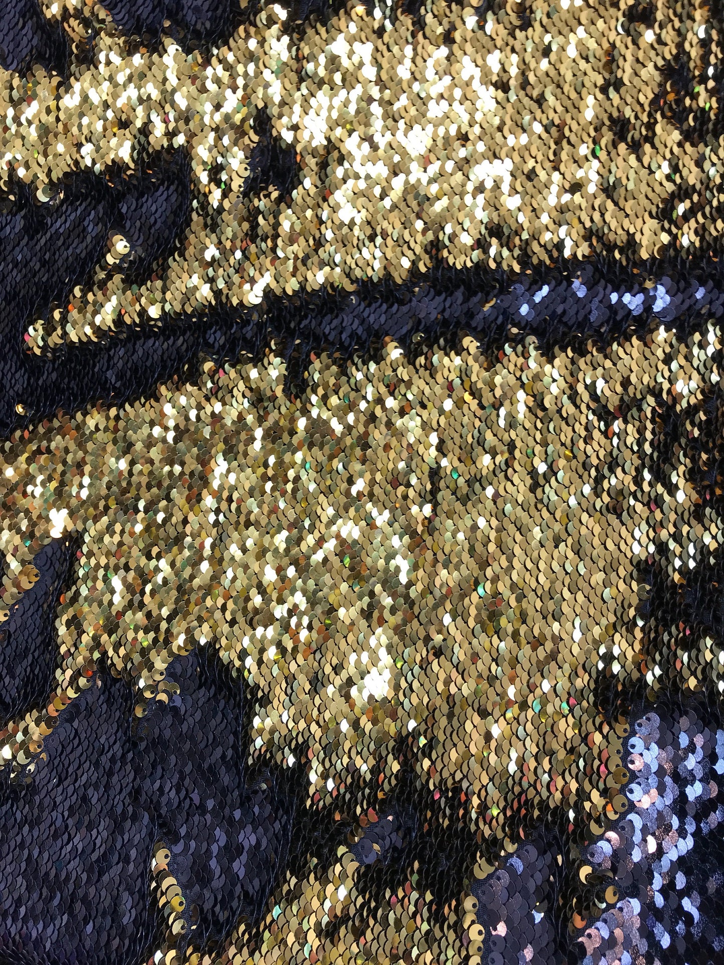 Black/gold flip up sequins reversible sequins on spandex base 2way stretch 58/60" Sold by the YD. Ships worldwide from Los Angeles CA USA.