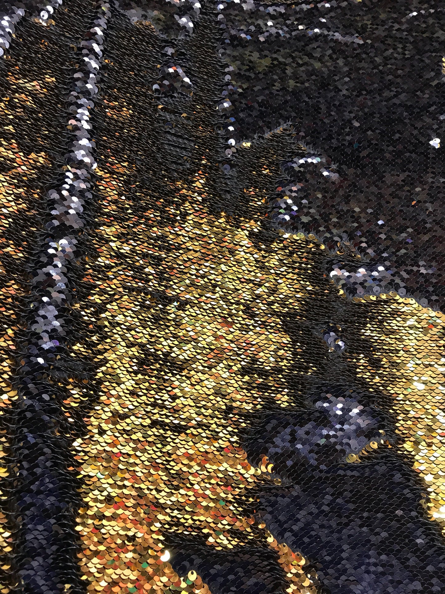 Black/gold flip up sequins reversible sequins on spandex base 2way stretch 58/60" Sold by the YD. Ships worldwide from Los Angeles CA USA.