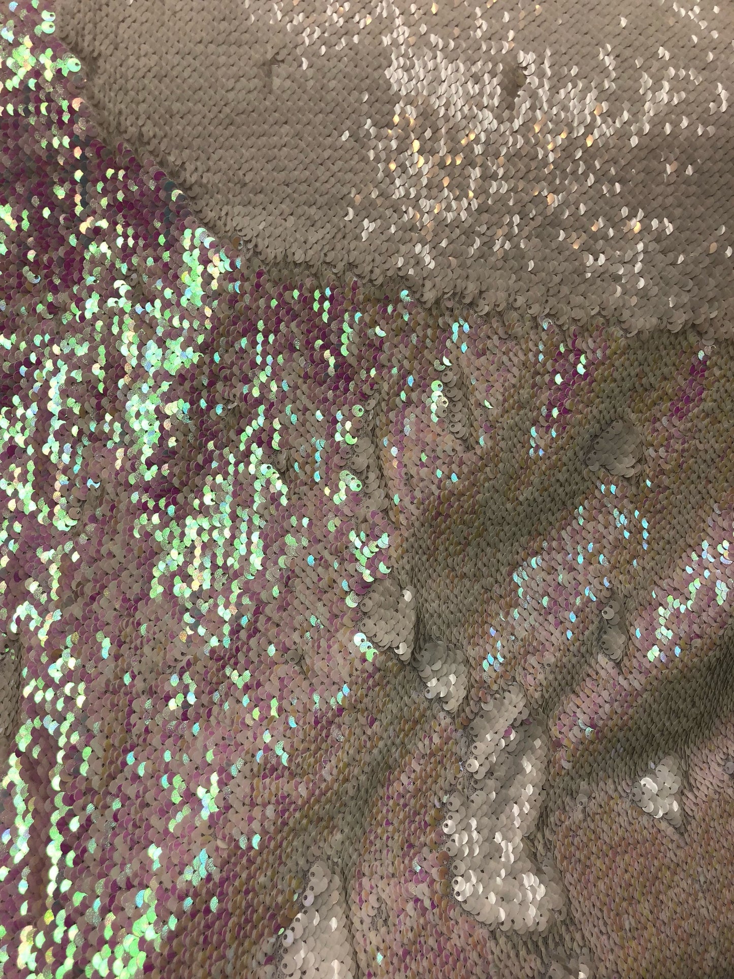 Mermaid sequins iridescent white 2tone with spandex base 2 way Stretch 58/60" Sold by the YD. Ships worldwide from Los Angeles California.