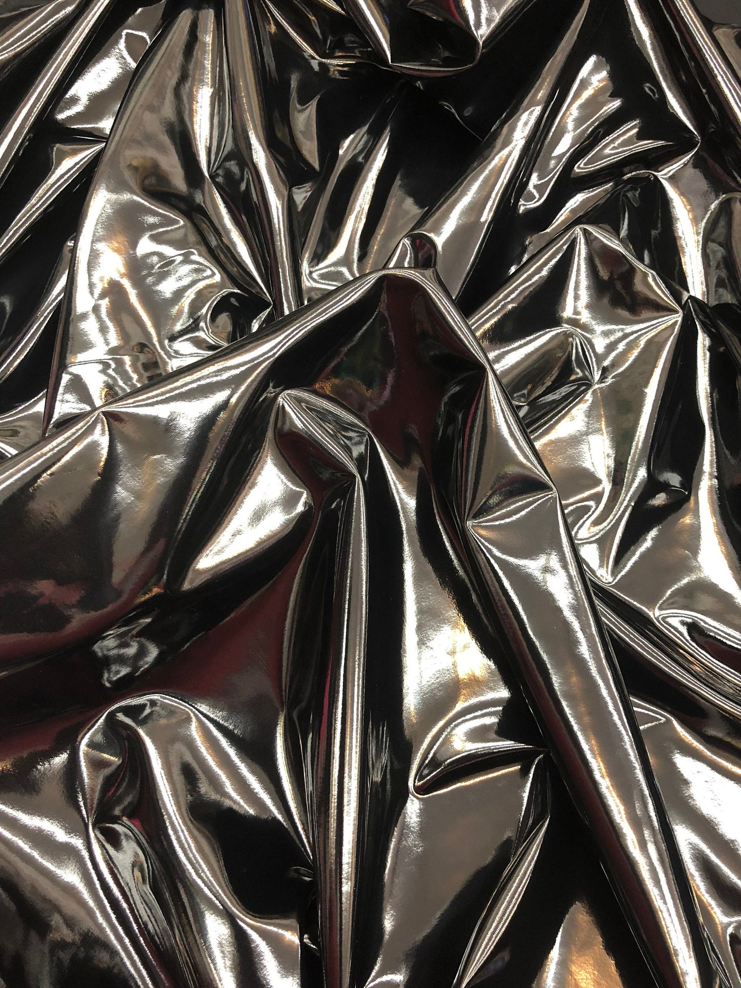 Shining black latex vinyl 4way stretch 58/60" Sold by the YD. Ships worldwide from Los Angeles California USA.