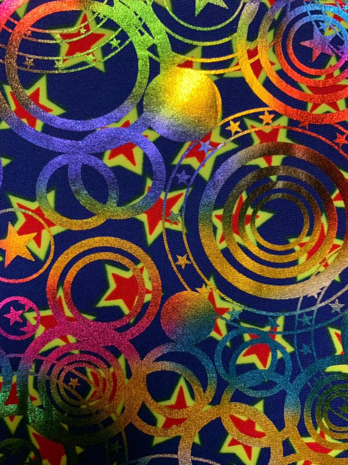 Stars and circles hologram design metallic nylon spandex 4way 58/60" Sold nubthe YD. Ships worldwide from Los Angeles California USA.