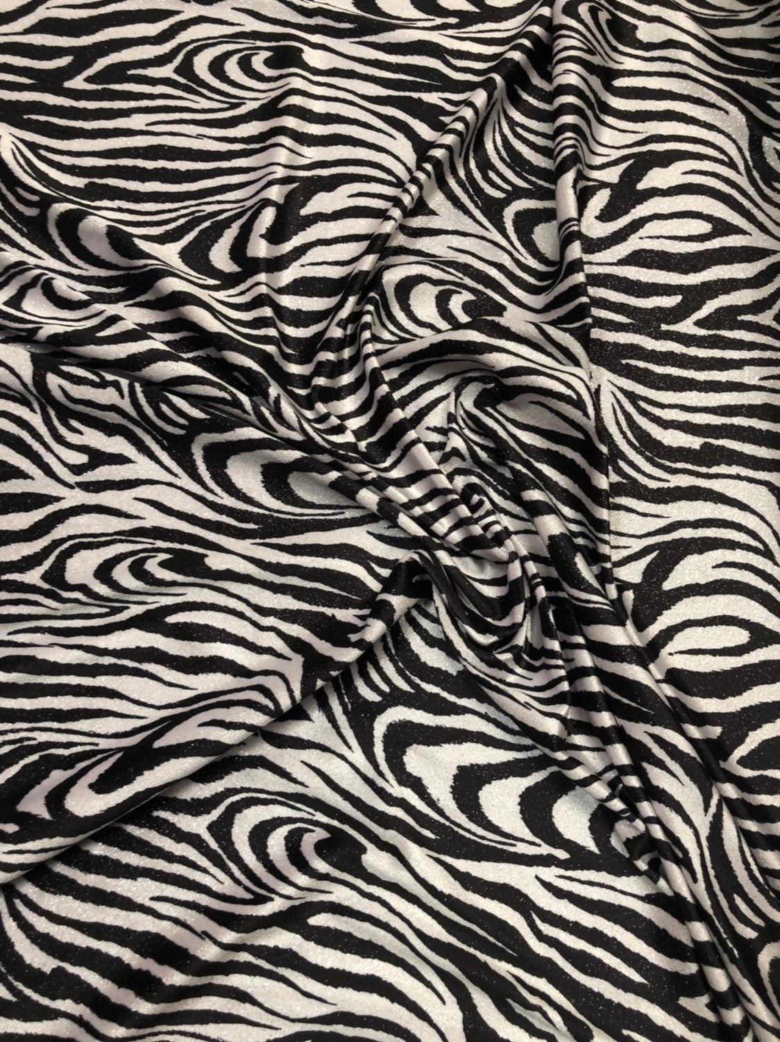 Zebra design with silver glitter on heavy stretch velvet 4way 58/60" Sold by the YD. Ships worldwide from Los Angeles California USA.