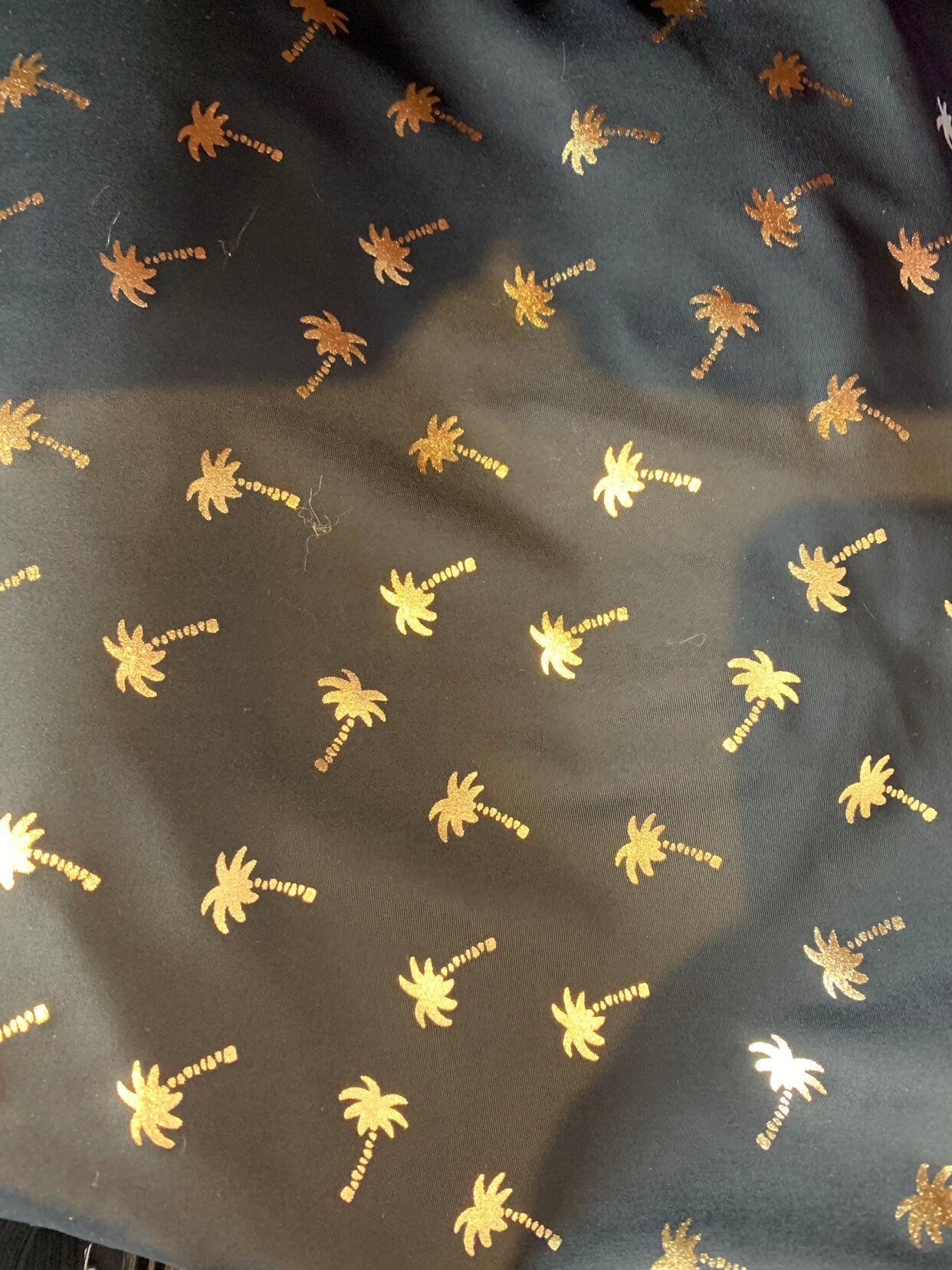 New metallic print nylon spandex palm tree design 4way stretch 58/60" Sold by the YD. Ships worldwide from Los Angeles California USA.