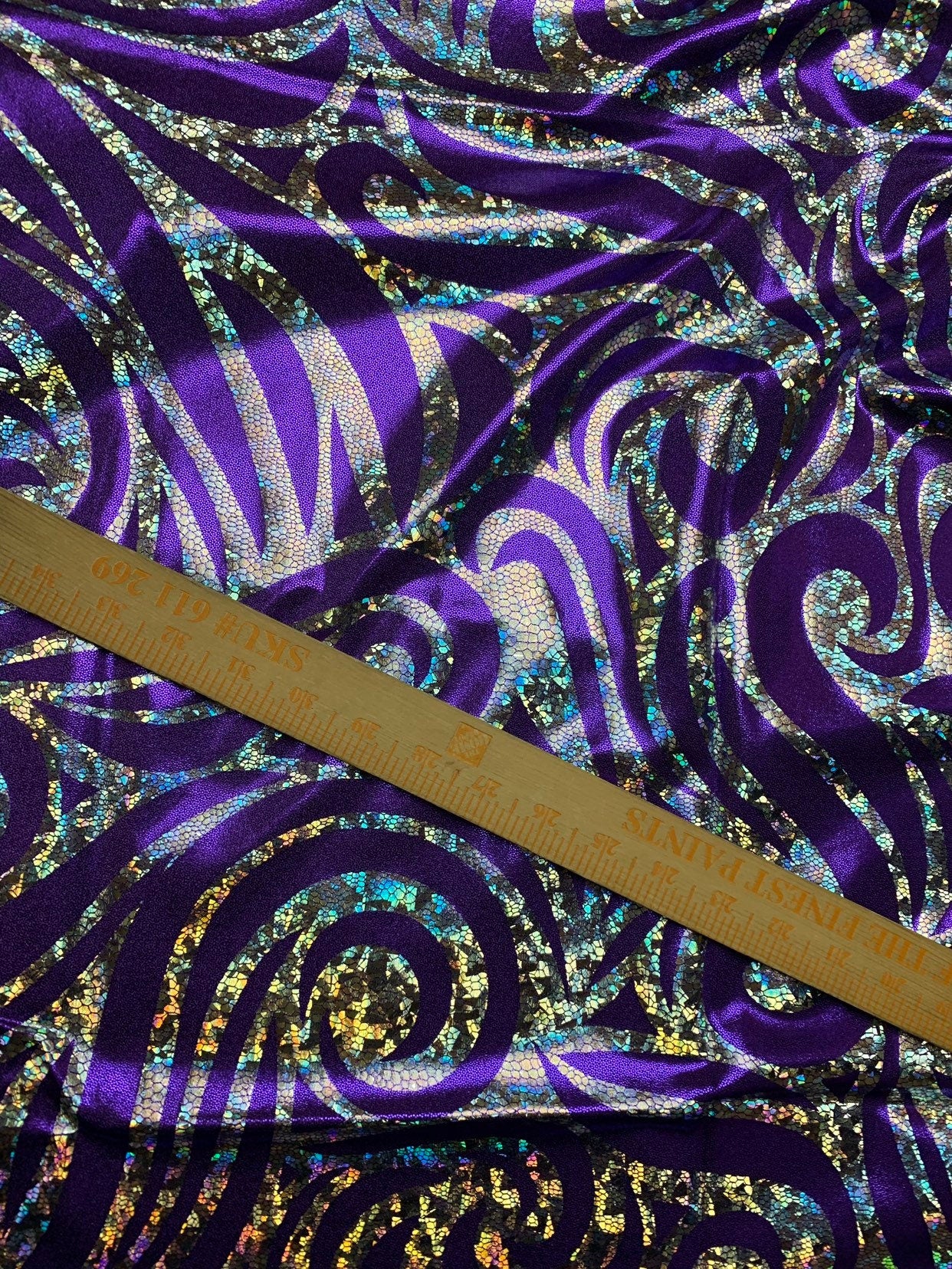 Metallic spandex with swirl hologram foil design 58/60" sold by the yd. Ships worldwide from Los Angeles CA United States.