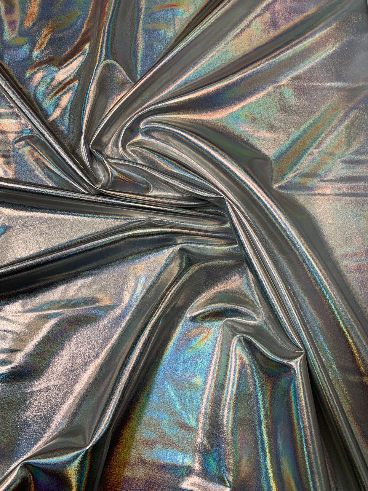 Iridescent silver all over foil metallic haevy nylon spandex 4way stretch 58/60" Sold bybthe YD. Ships worldwide from Los Angeles California