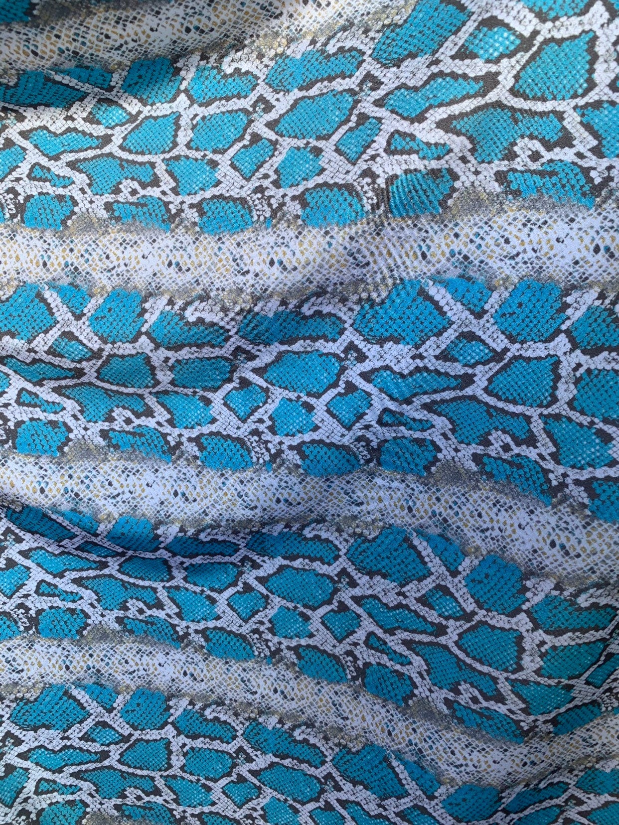 New snake print white/blue/gray print on nylon spandex 4way stretch 58/60" Sold by the YD. Ships worldwide from Los Angeles California USA.