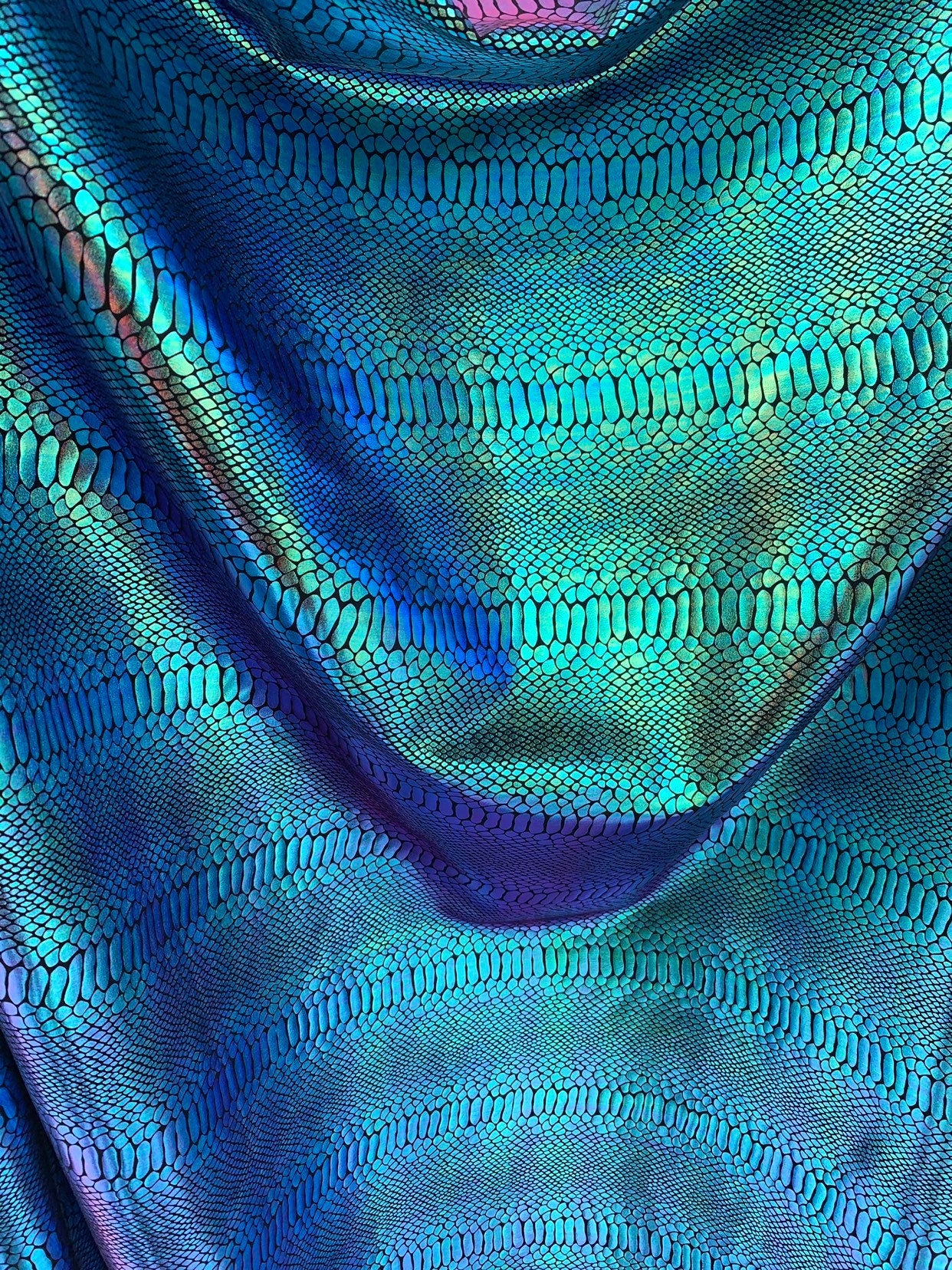 New Iridescent snake foil 2 tone blue/green metallic nylon spandex 4way stretch 58/60" Sold by the YD. Ships worldwide from Los Angeles CA.