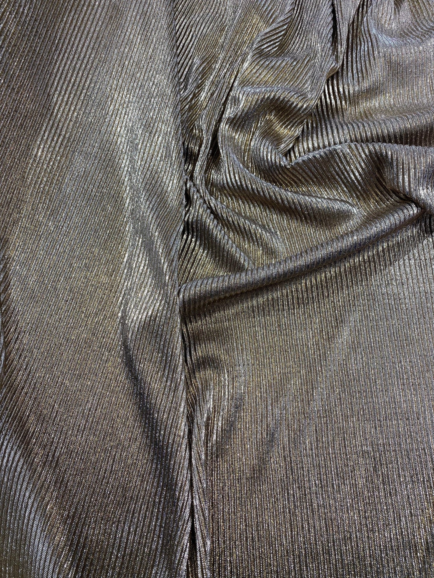New metallic poly pleated black/gold medium weight fabric 2-way stretch 58/60” Sold by the YD. Ships worldwide from Los Angeles CA USA.
