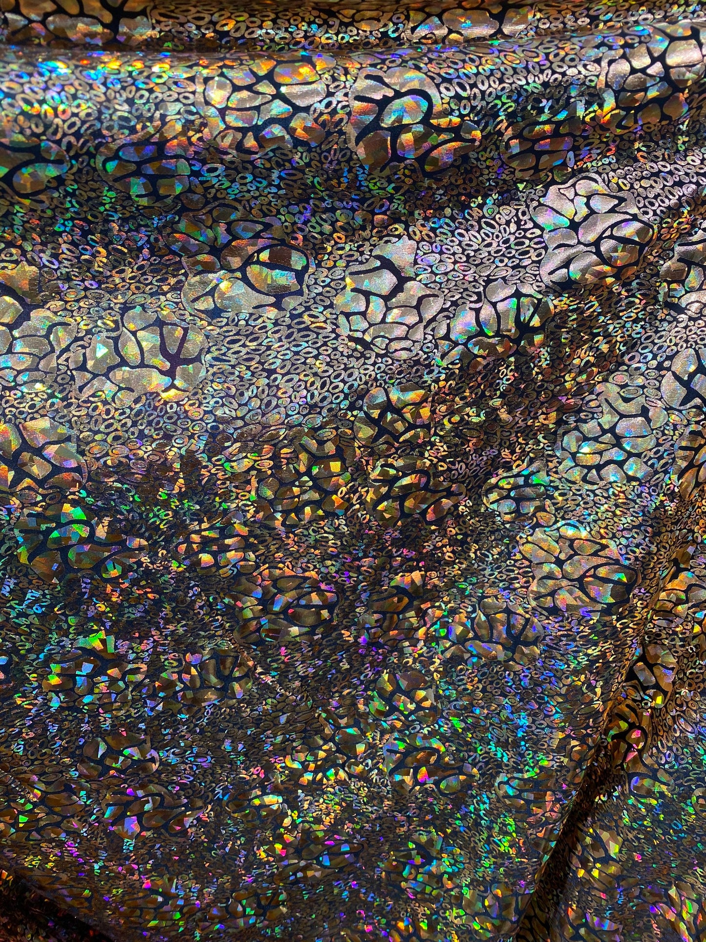 New exotic animal print hologram metallic foil on poly spandex light weight 2-way stretch 58/60” Sold by the YD. Ships worldwide from LA CA
