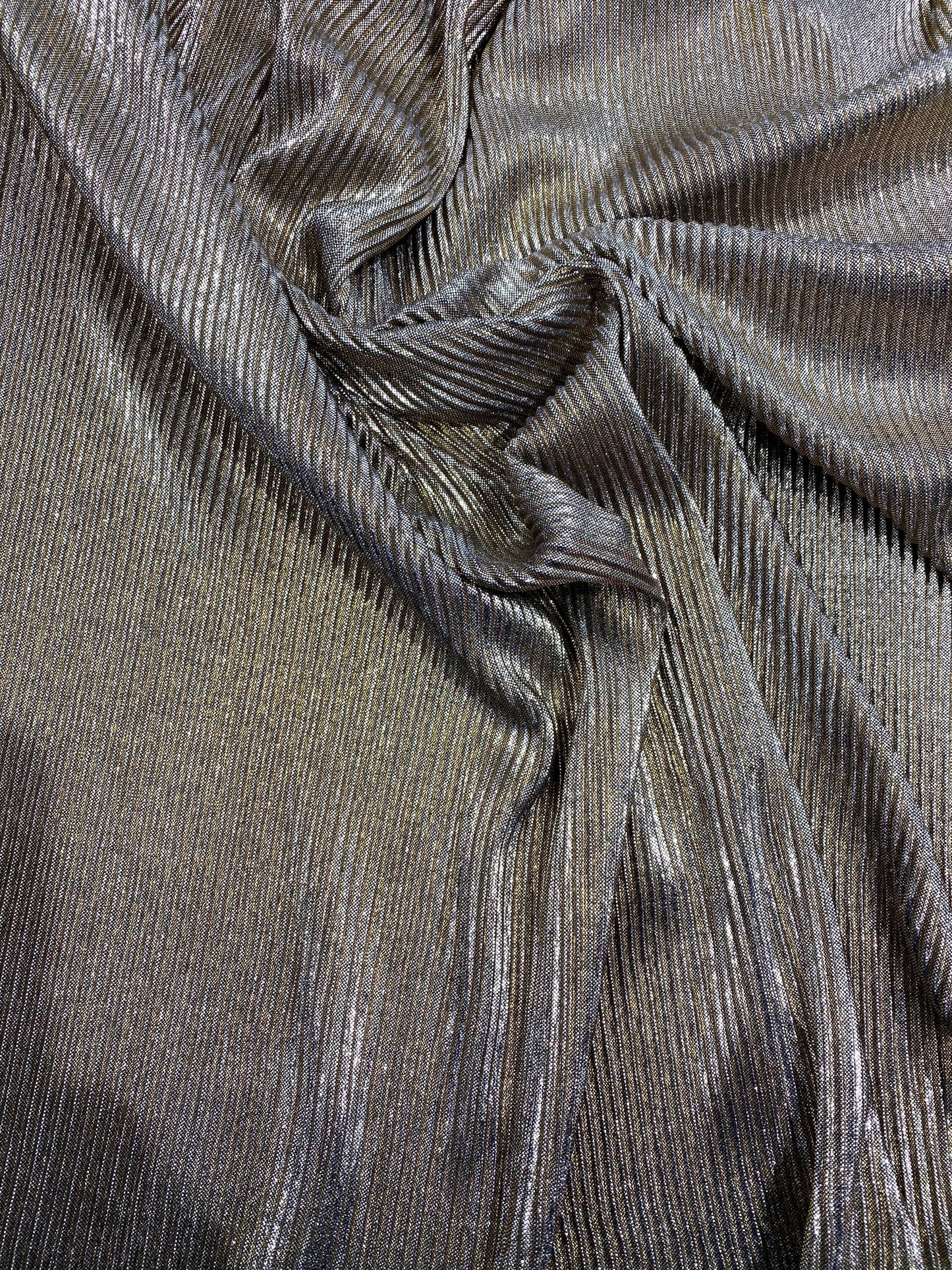New metallic poly pleated black/gold medium weight fabric 2-way stretch 58/60” Sold by the YD. Ships worldwide from Los Angeles CA USA.