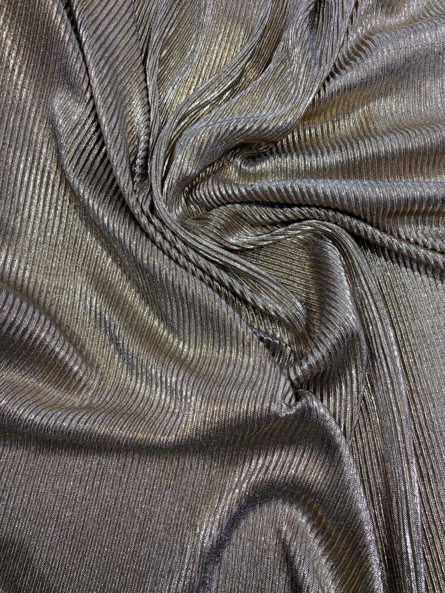 New metallic poly pleated black/gold medium weight fabric 2-way stretch 58/60” Sold by the YD. Ships worldwide from Los Angeles CA USA.