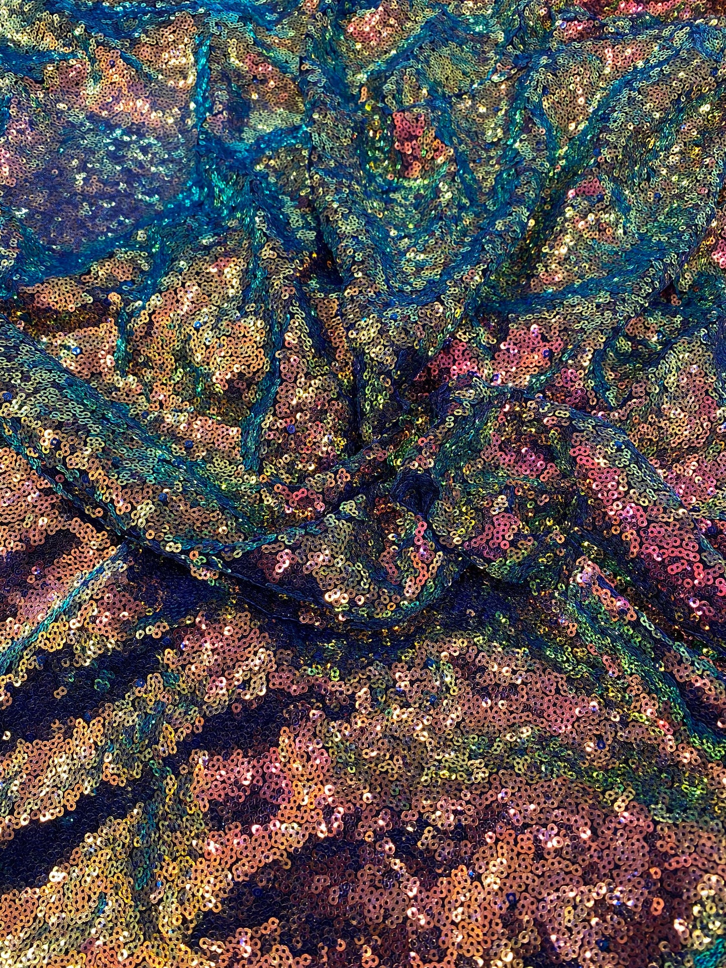 New cosmic iridescent sequins sapphire bronze color on stretch mesh 2-way stretch 58/60” Sold by the YD. Ships worldwide from Los Angeles CA