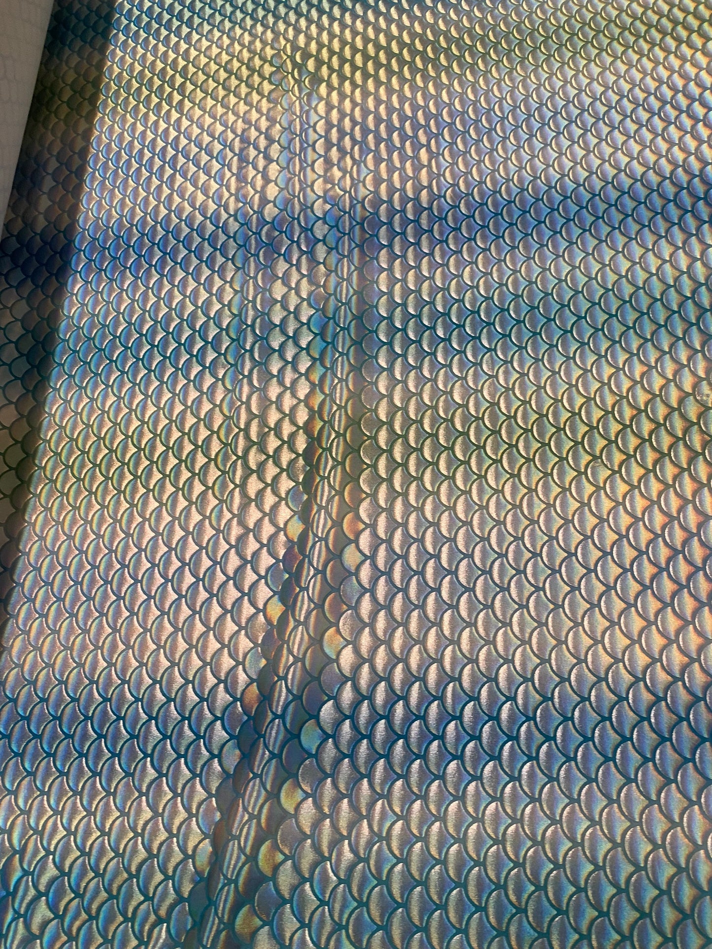 New Rainbow mermaid design blue/silver iridescent metallic nylon spandex 4-way stretch 58/60” Sold by the YD. Ships worldwide from L.A CA.