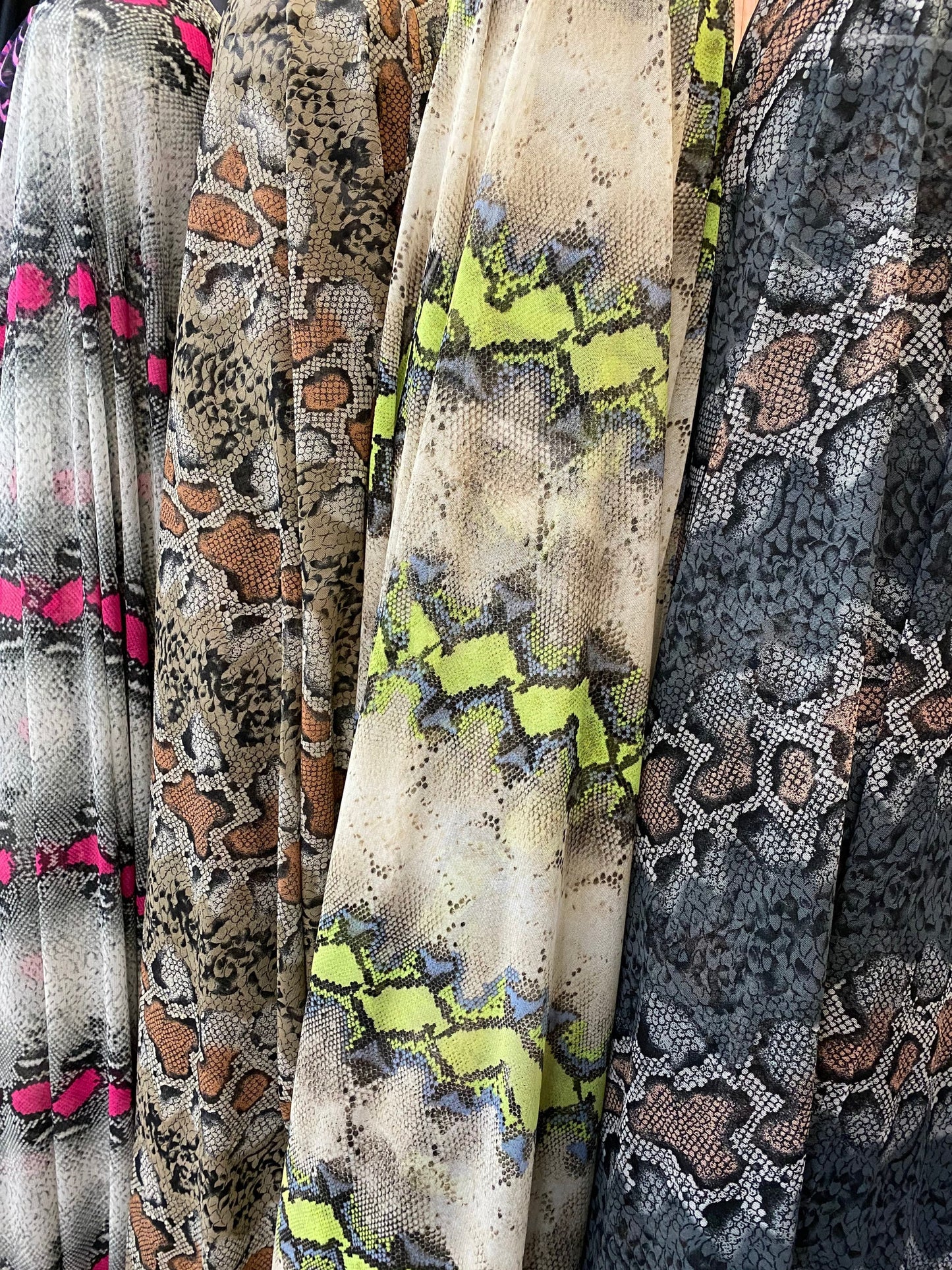 New power mesh exotic snake design it glows in the dark with UV lights 4-way Stretch 58/60” Sold by the YD. Ships worldwide