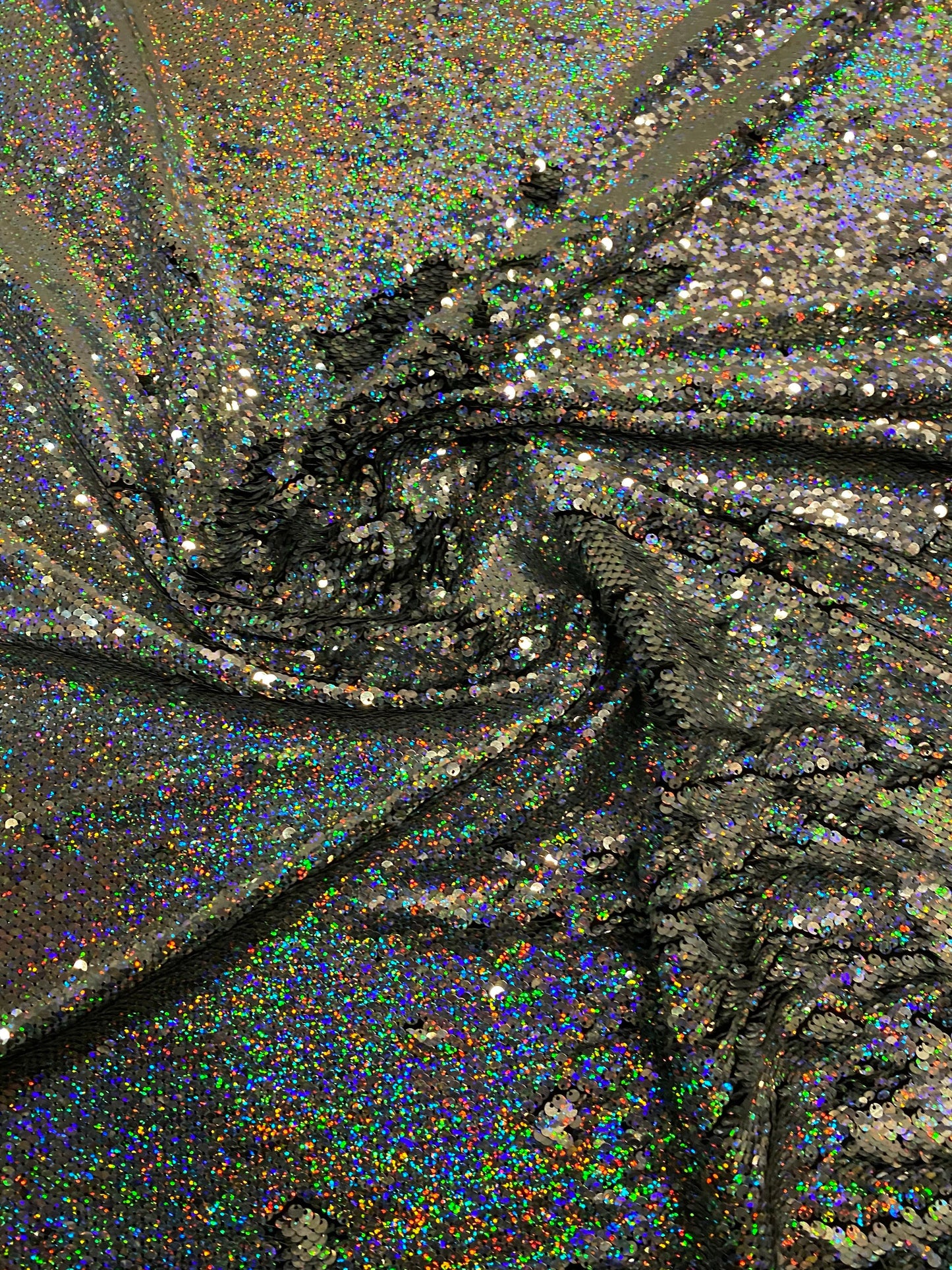 New hologram silver/silver reversible flip up sequins on spandex base 2-way stretch 58/60” Sold by the YD. Ships worldwide from Los Angeles