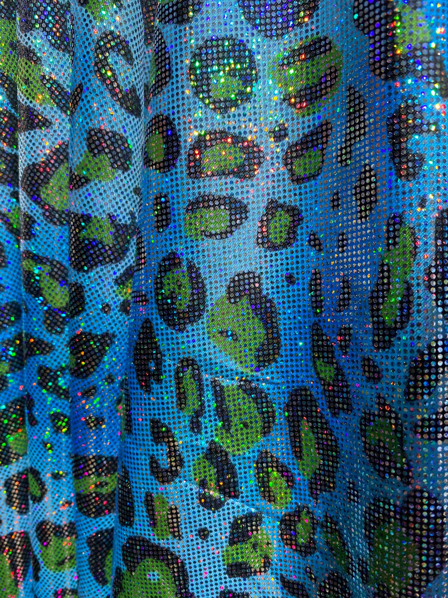 Hologram exotic leopard design metallic nylon spandex 4-way stretch 58/60” Sold by the YD. Ships worldwide from Los Angeles California USA.