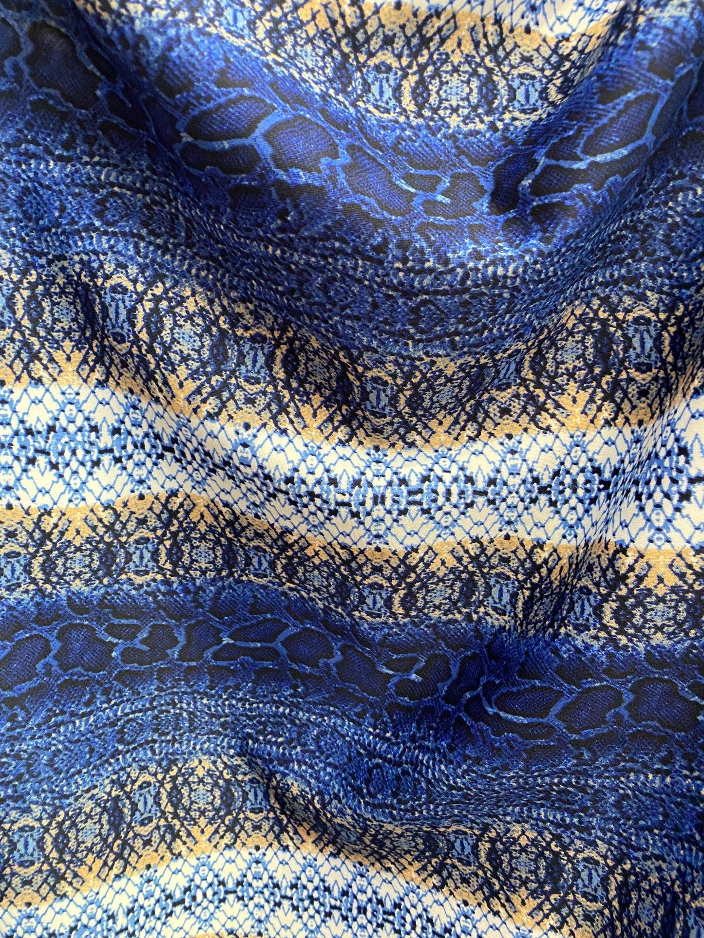 New Exotic snake design Sapphire/gold/beige print on poly techno spandex 2-way stretch 58/60” Sold by the YD. Ships worldwide from L.A CA