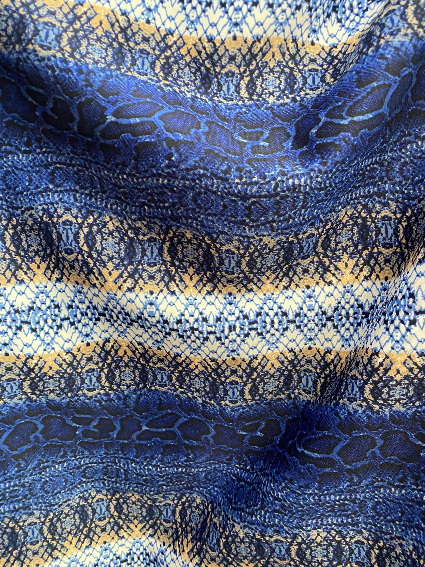 New Exotic snake design Sapphire/gold/beige print on poly techno spandex 2-way stretch 58/60” Sold by the YD. Ships worldwide from L.A CA