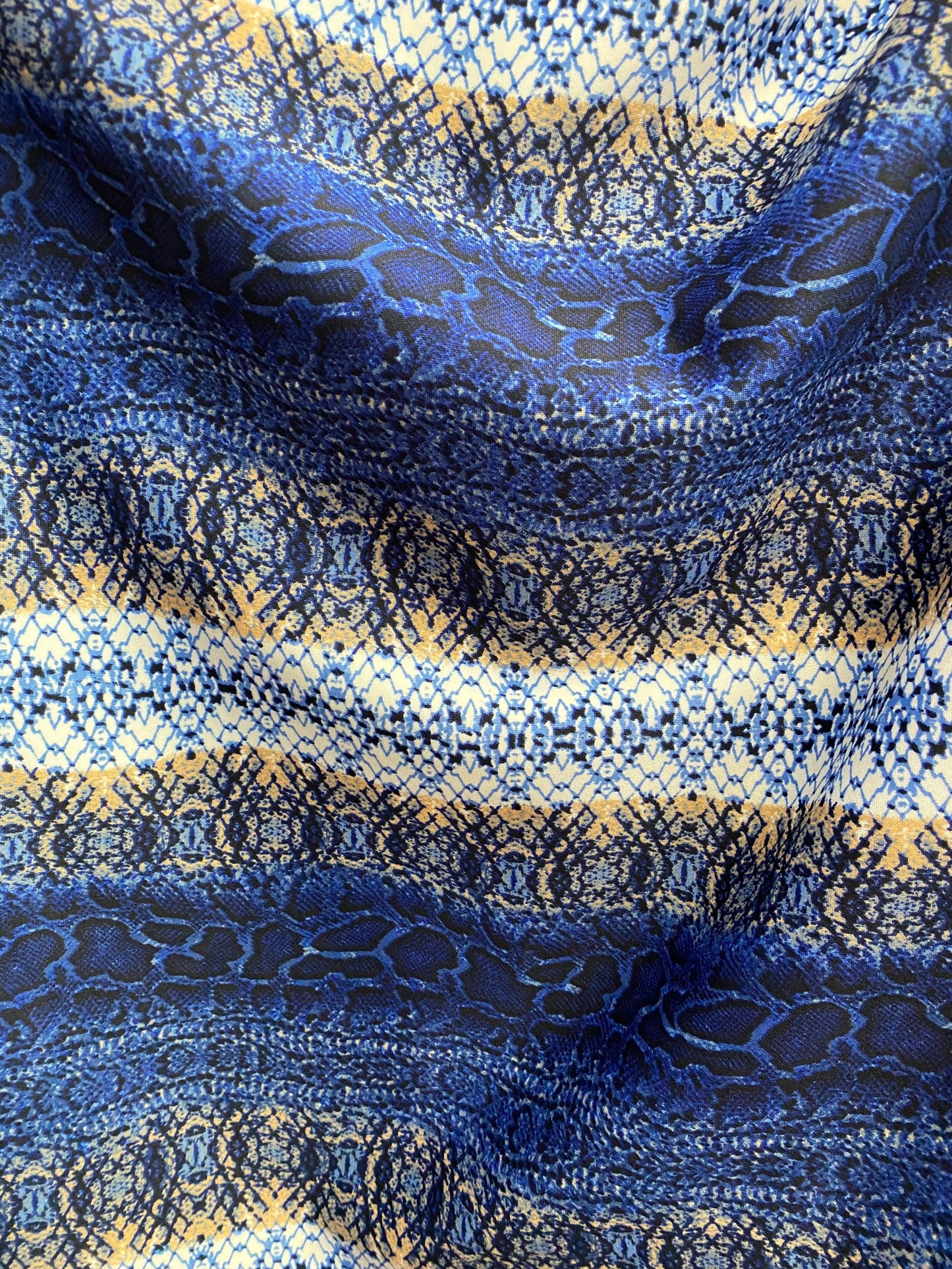 New Exotic snake design Sapphire/gold/beige print on poly techno spandex 2-way stretch 58/60” Sold by the YD. Ships worldwide from L.A CA