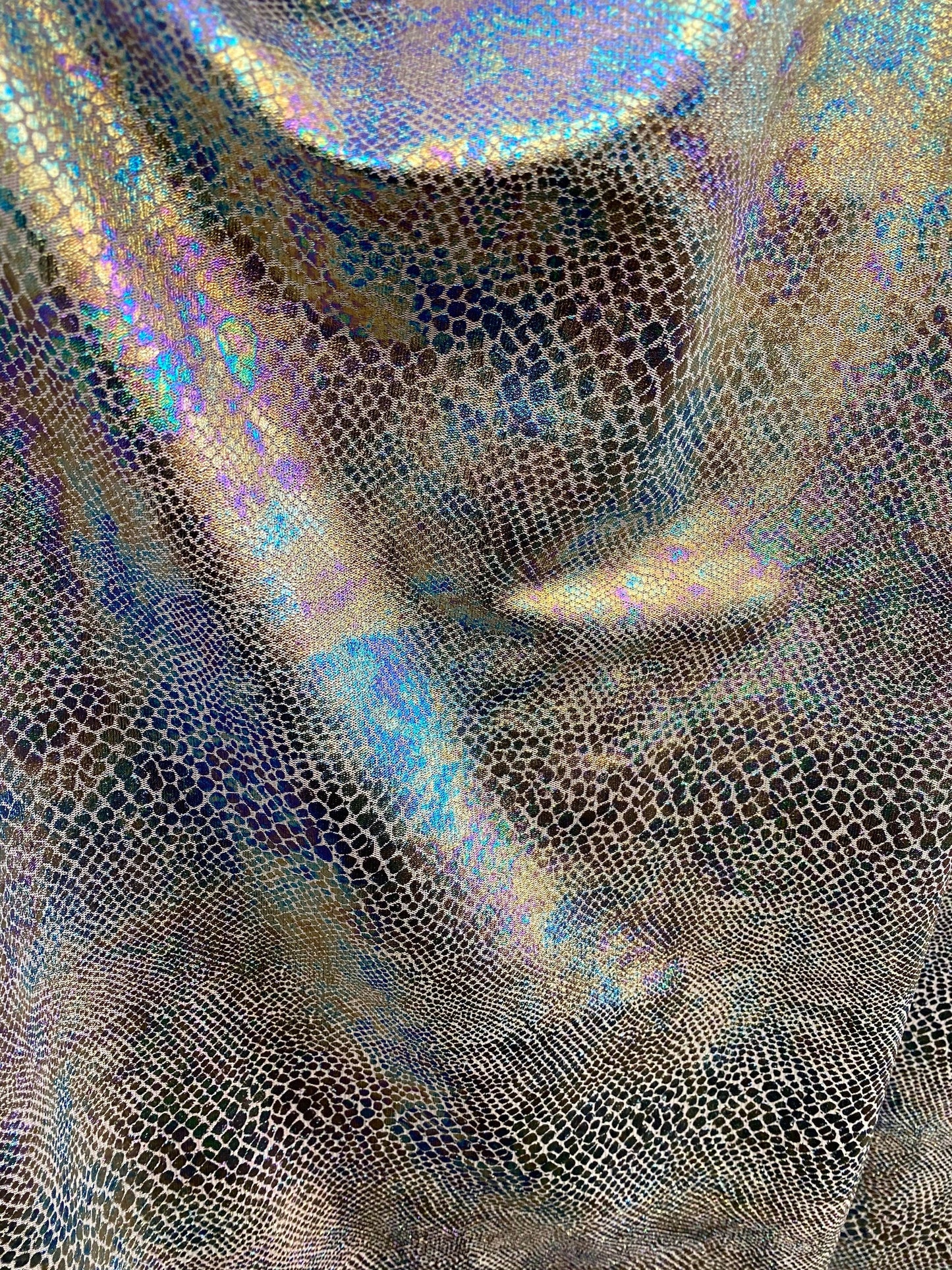 New Iridescent snake design print on silver poly mesh 2-way Stretch 58/60” Sold by the YD. Ships Worldwide from Los Angeles California USA.