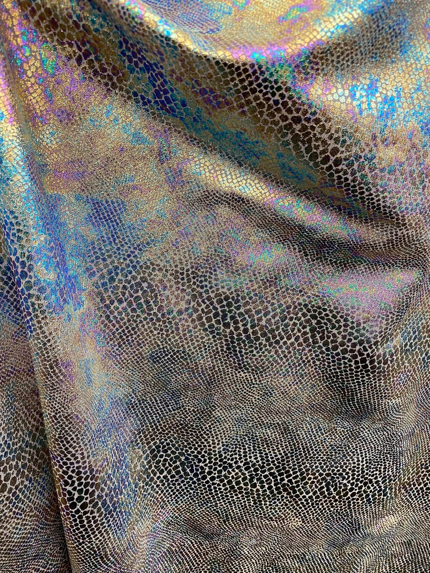 New Iridescent snake design print on silver poly mesh 2-way Stretch 58/60” Sold by the YD. Ships Worldwide from Los Angeles California USA.