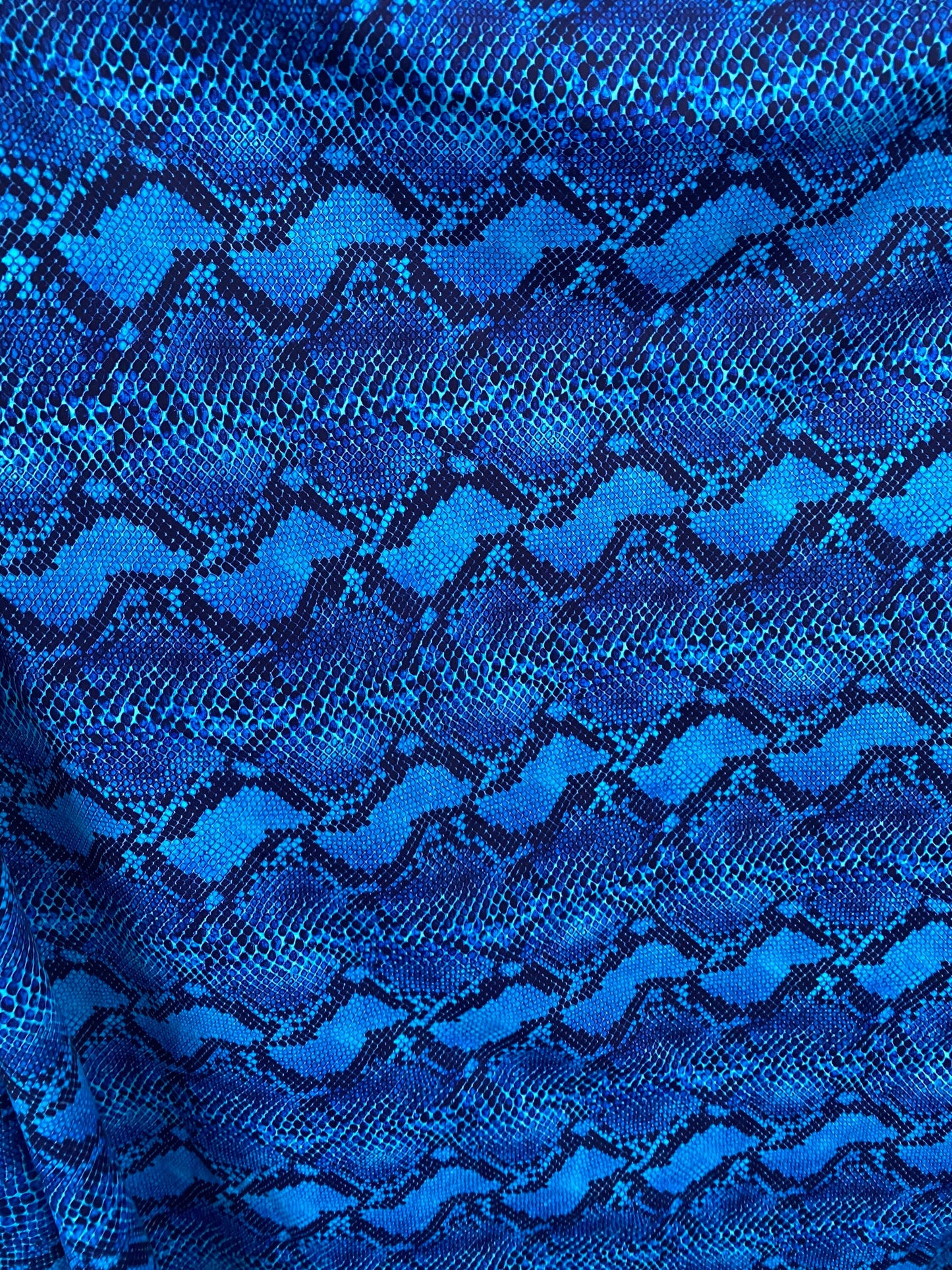 Serpent design Sapphire/Black print on nylon spandex 4-way stretch 58/60” Sold by the YD. Ships worldwide from Los Angeles California USA.