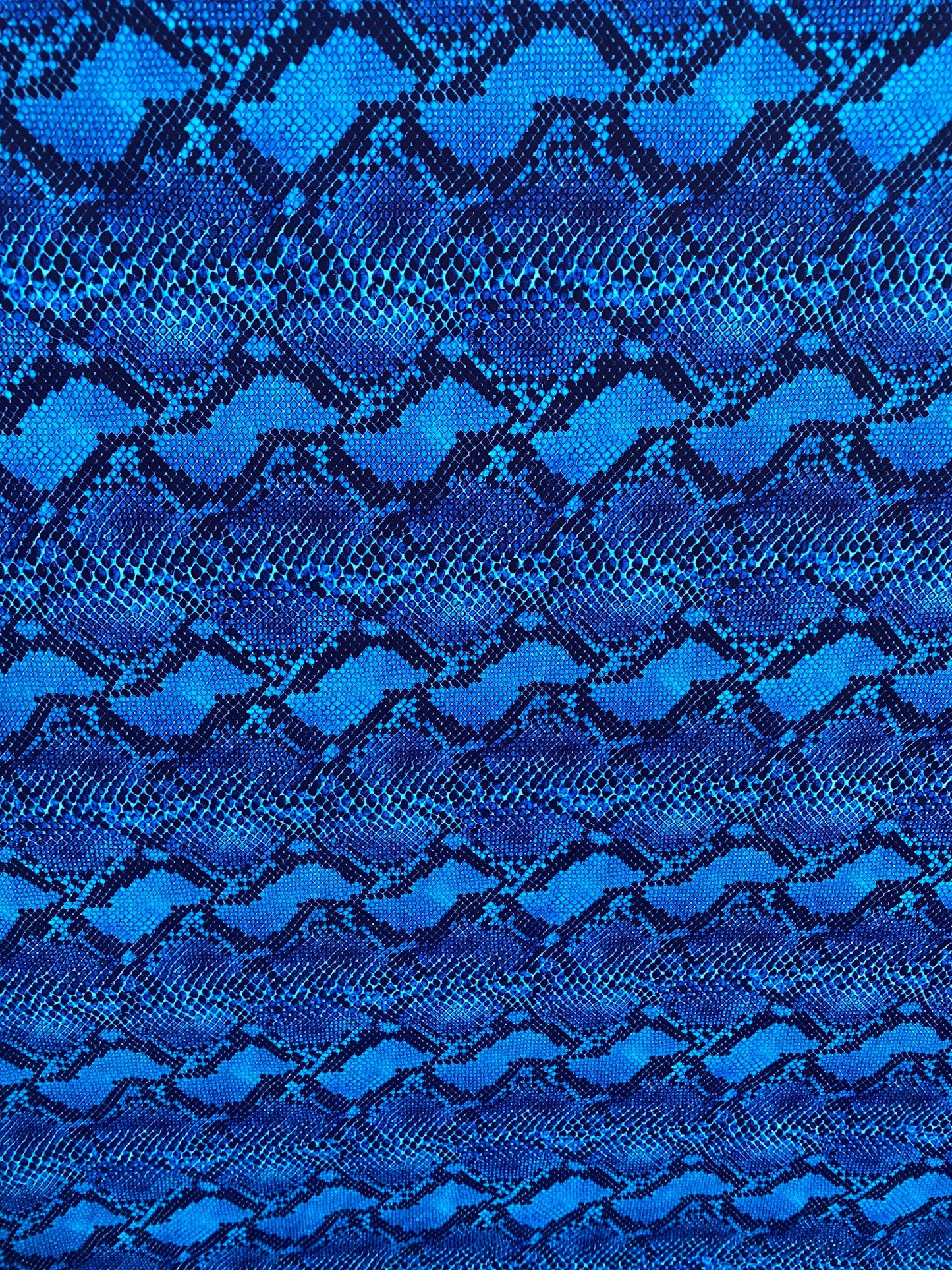 Serpent design Sapphire/Black print on nylon spandex 4-way stretch 58/60” Sold by the YD. Ships worldwide from Los Angeles California USA.