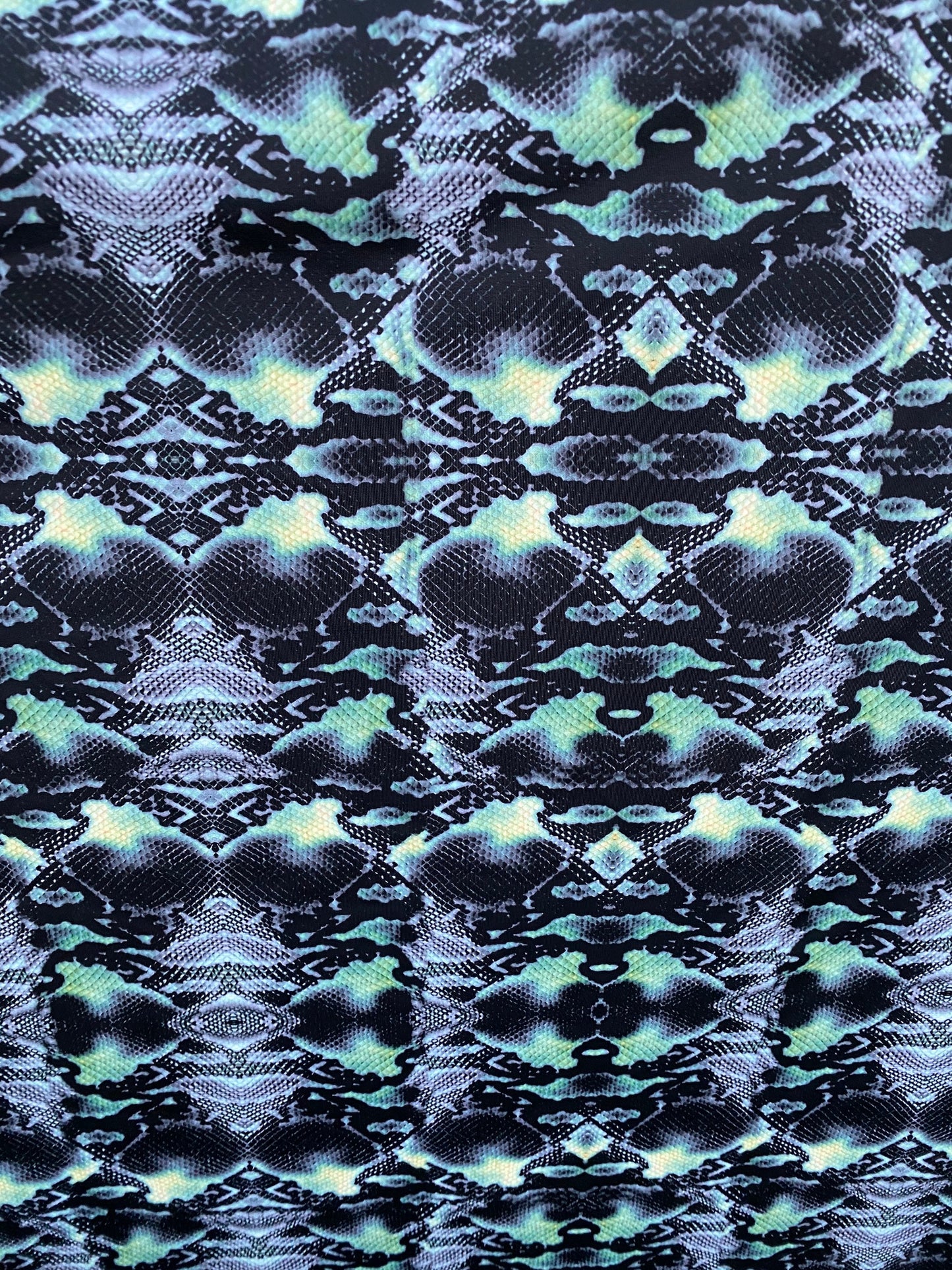 Serpent design Black/Green print on nylon spandex 4-way stretch 58/60” Sold by the YD. Ships worldwide from Los Angeles California USA.