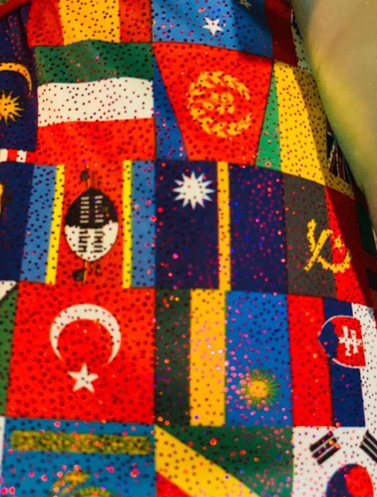 Internacional flags design print on best quality of nylon spandex with foggy foil all over 4-way stretch 58/60” Sold by the YD.