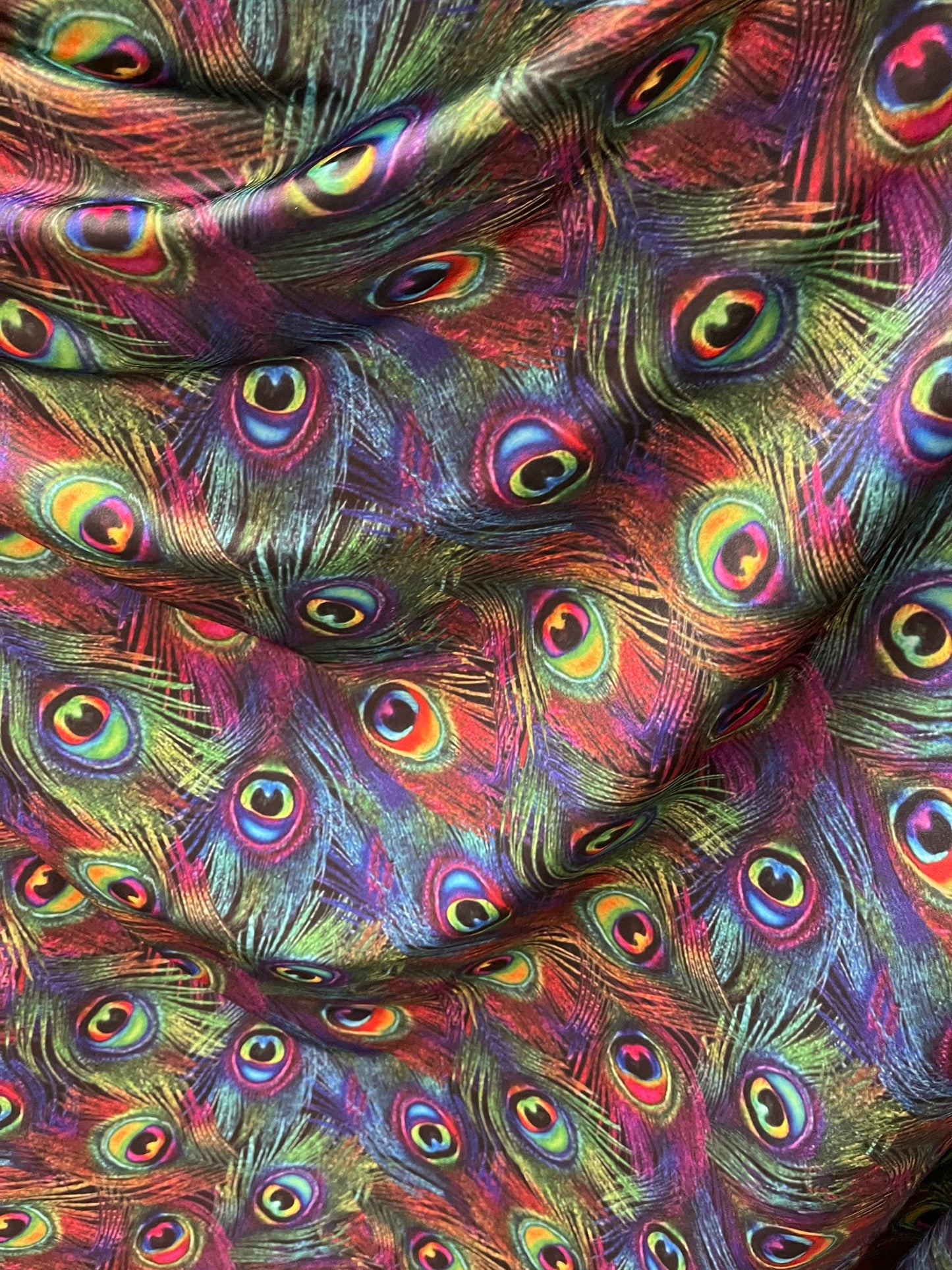 Peacock feathers design rainbow print on nylon spandex 4way Stretch 58/60” Sold by the YD. Ships worldwide from Los Angeles California USA.