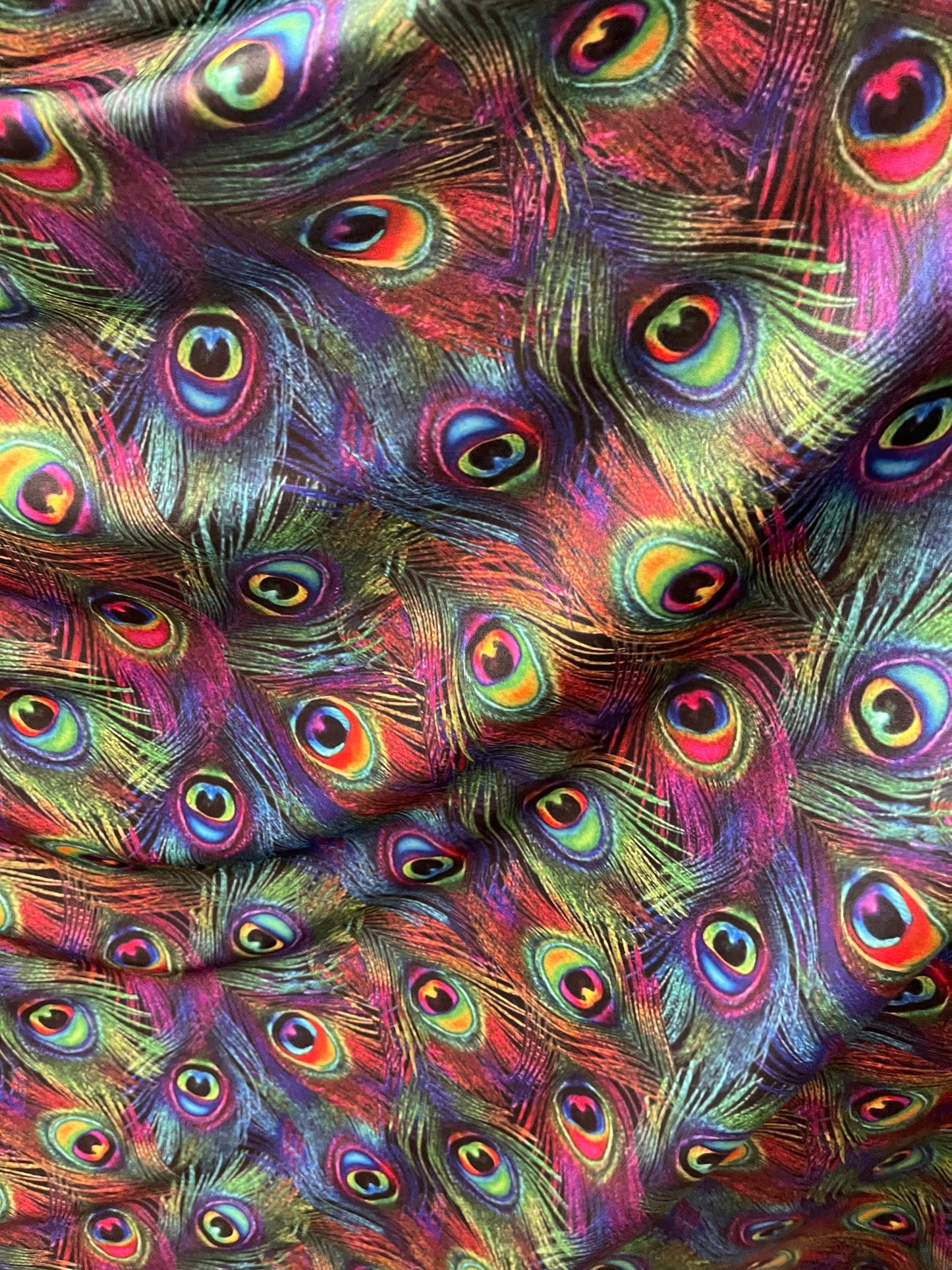 Peacock feathers design rainbow print on nylon spandex 4way Stretch 58/60” Sold by the YD. Ships worldwide from Los Angeles California USA.