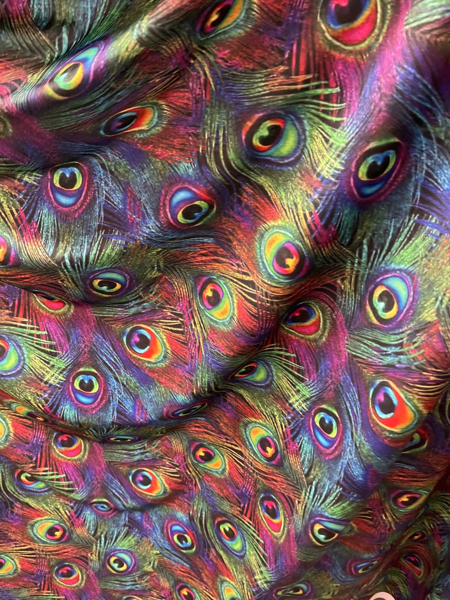 Peacock feathers design rainbow print on nylon spandex 4way Stretch 58/60” Sold by the YD. Ships worldwide from Los Angeles California USA.