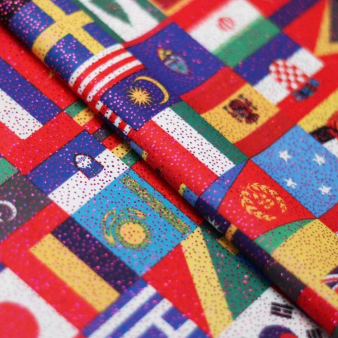 Internacional flags design print on best quality of nylon spandex with foggy foil all over 4-way stretch 58/60” Sold by the YD.