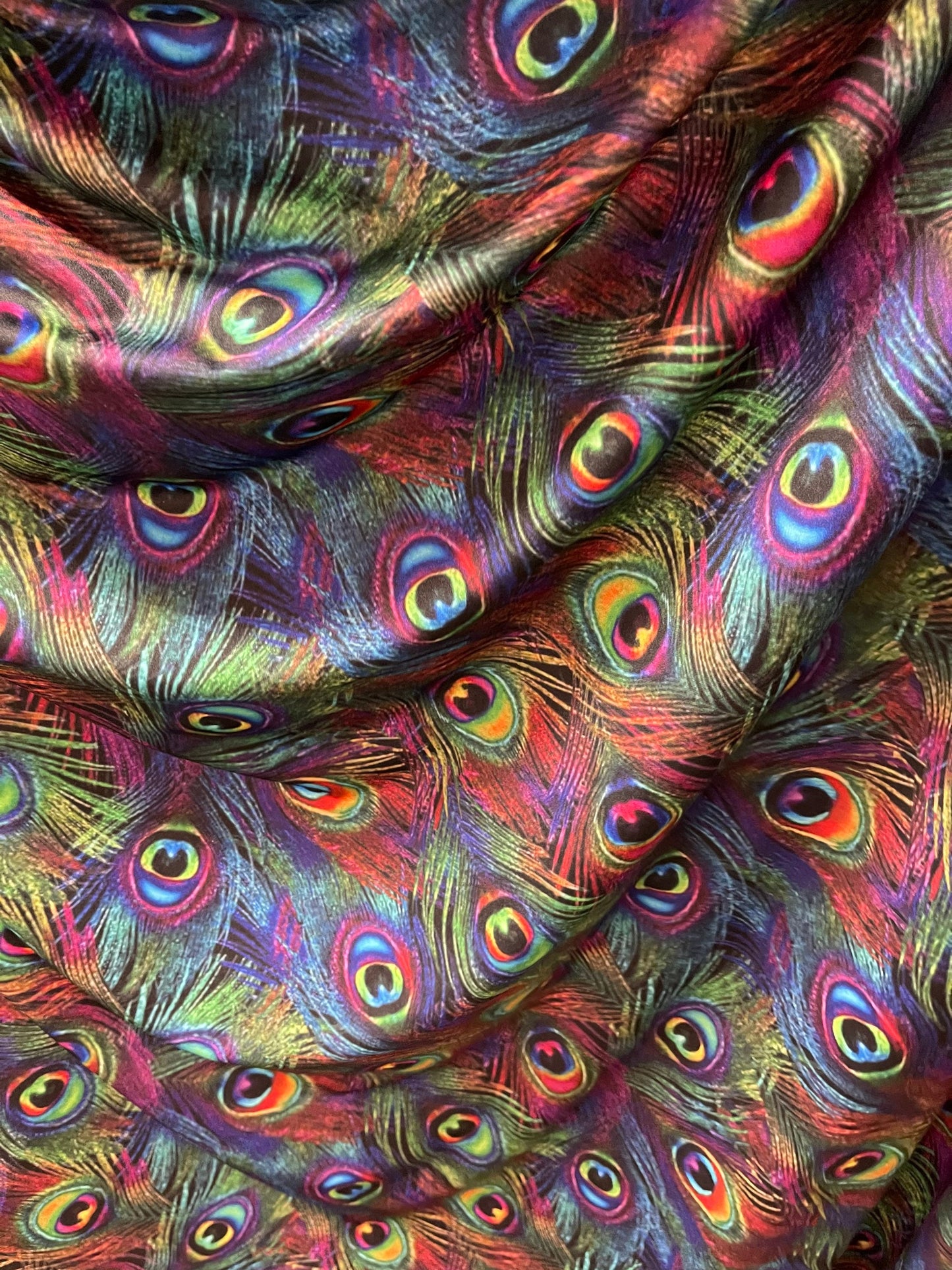 Peacock feathers design rainbow print on nylon spandex 4way Stretch 58/60” Sold by the YD. Ships worldwide from Los Angeles California USA.