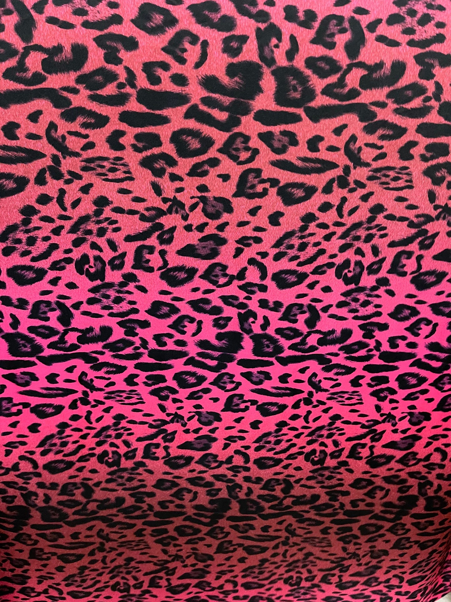 Exotic leopard design print on nylon spandex ;-way stretch Hop pink/black 58/60” Sold by the YD. Ships Worldwide from Los Angeles California
