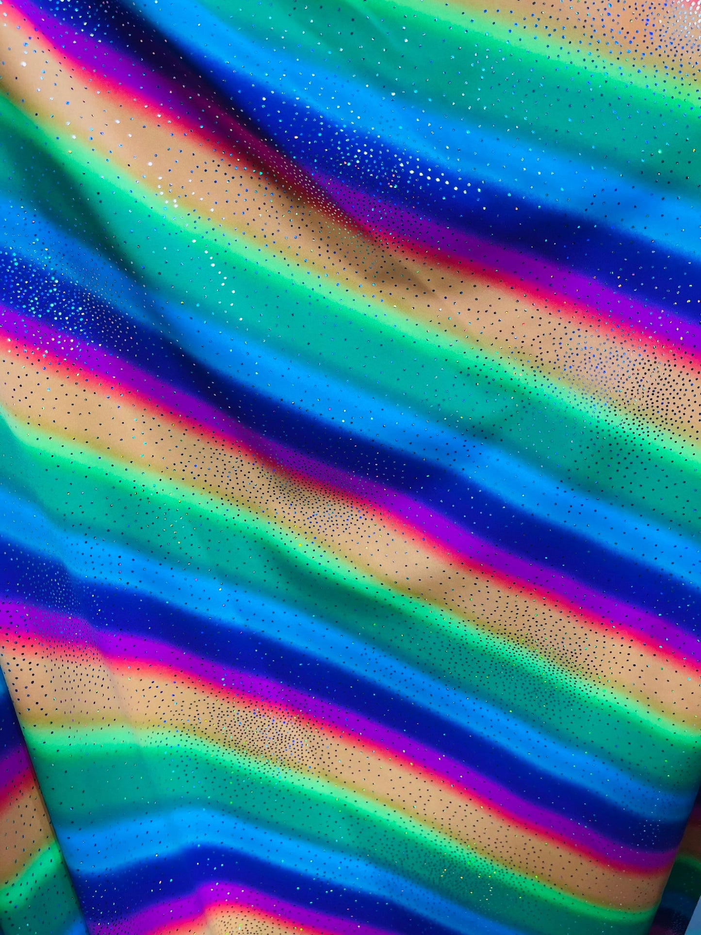 New Rainbow design with sparkling foil it glows in the dark best quality of nylon spandex 4-way stretch 58/60” Sold by the YD.