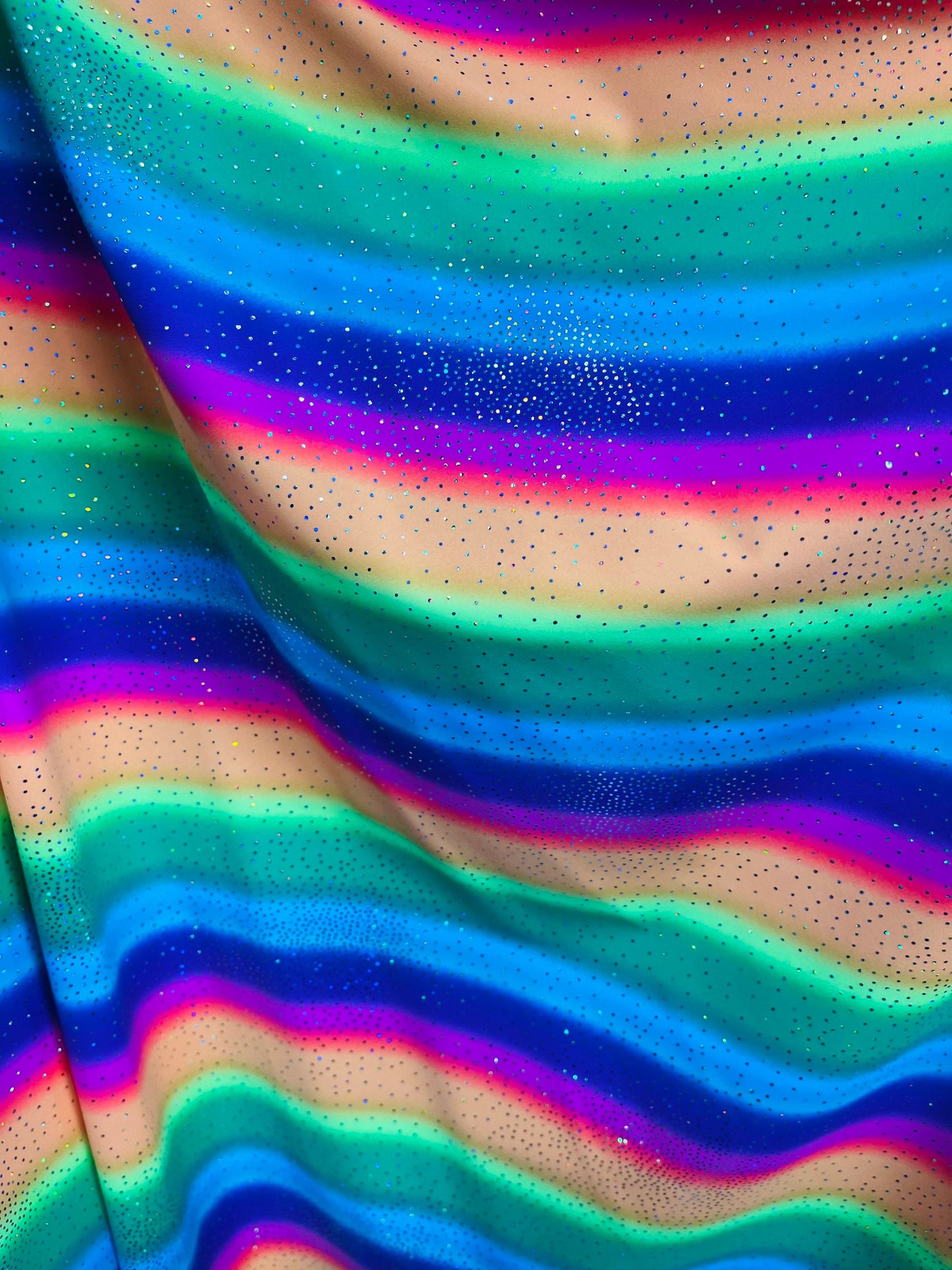 New Rainbow design with sparkling foil it glows in the dark best quality of nylon spandex 4-way stretch 58/60” Sold by the YD.