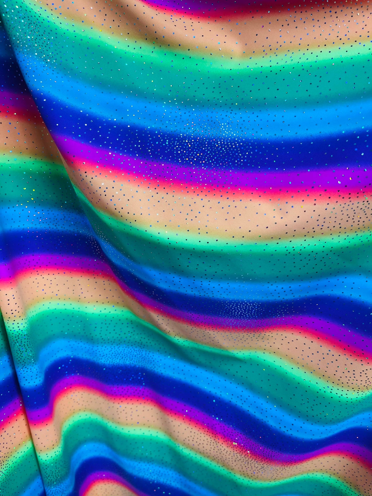 New Rainbow design with sparkling foil it glows in the dark best quality of nylon spandex 4-way stretch 58/60” Sold by the YD.
