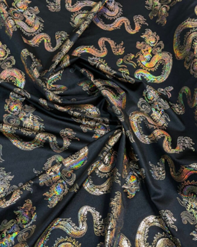 New Dragon design print on metallic nylon spandex Black Iridescent gold 4-way stretch spandex 58/60” Sold by the YD. Ships worldwide