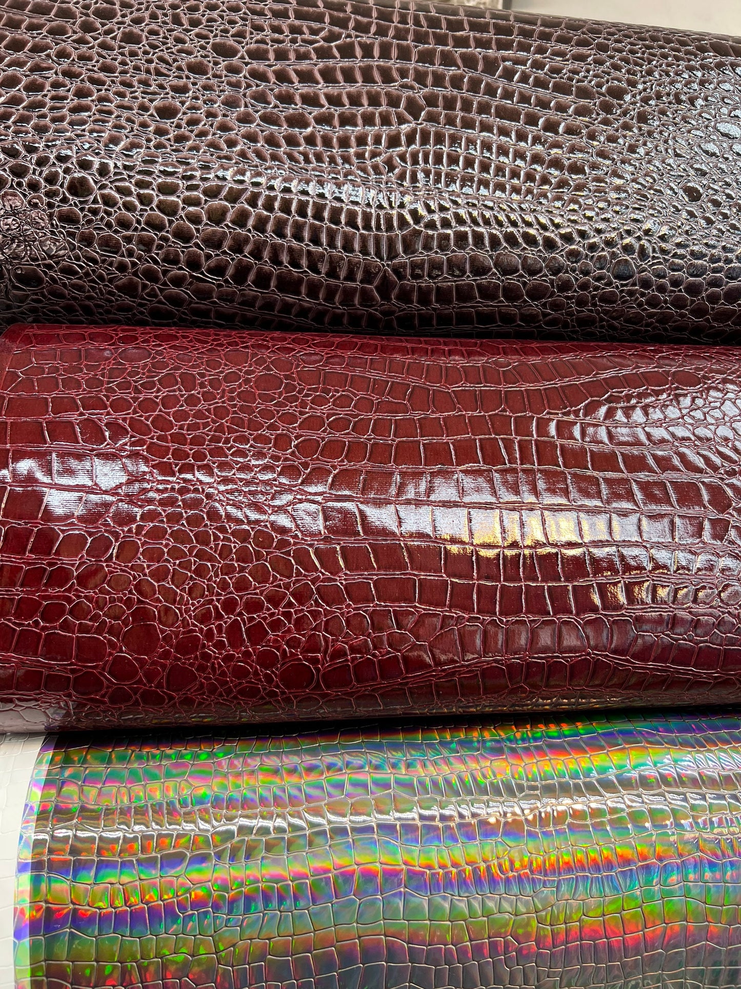 Crocodile design super shiny vinyl non stretch 58/60” Sold by the YD. Ships worldwide from Los Angeles California USA.