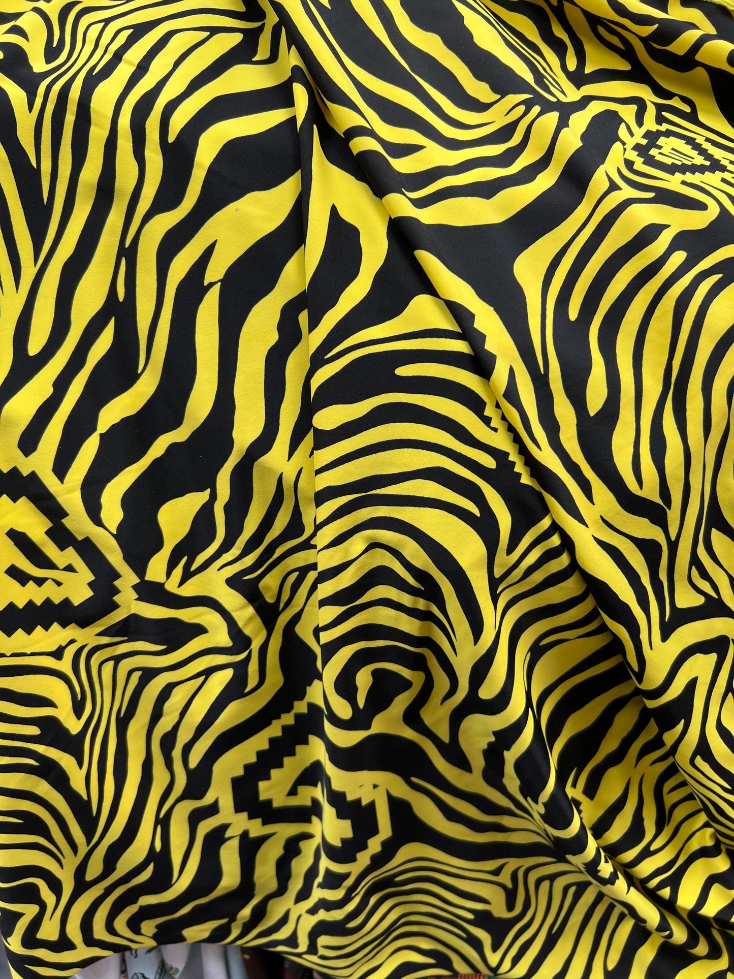 Exotic zebra design black/yellow print on nylon spandex 4way stretch 58/60” Sold by the YD. Ships worldwide from Los Angeles California USA.