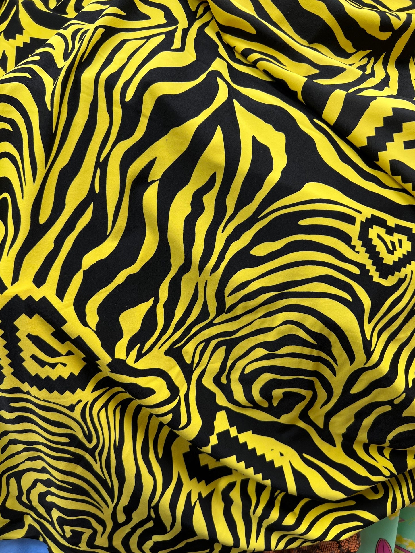 Exotic zebra design black/yellow print on nylon spandex 4way stretch 58/60” Sold by the YD. Ships worldwide from Los Angeles California USA.