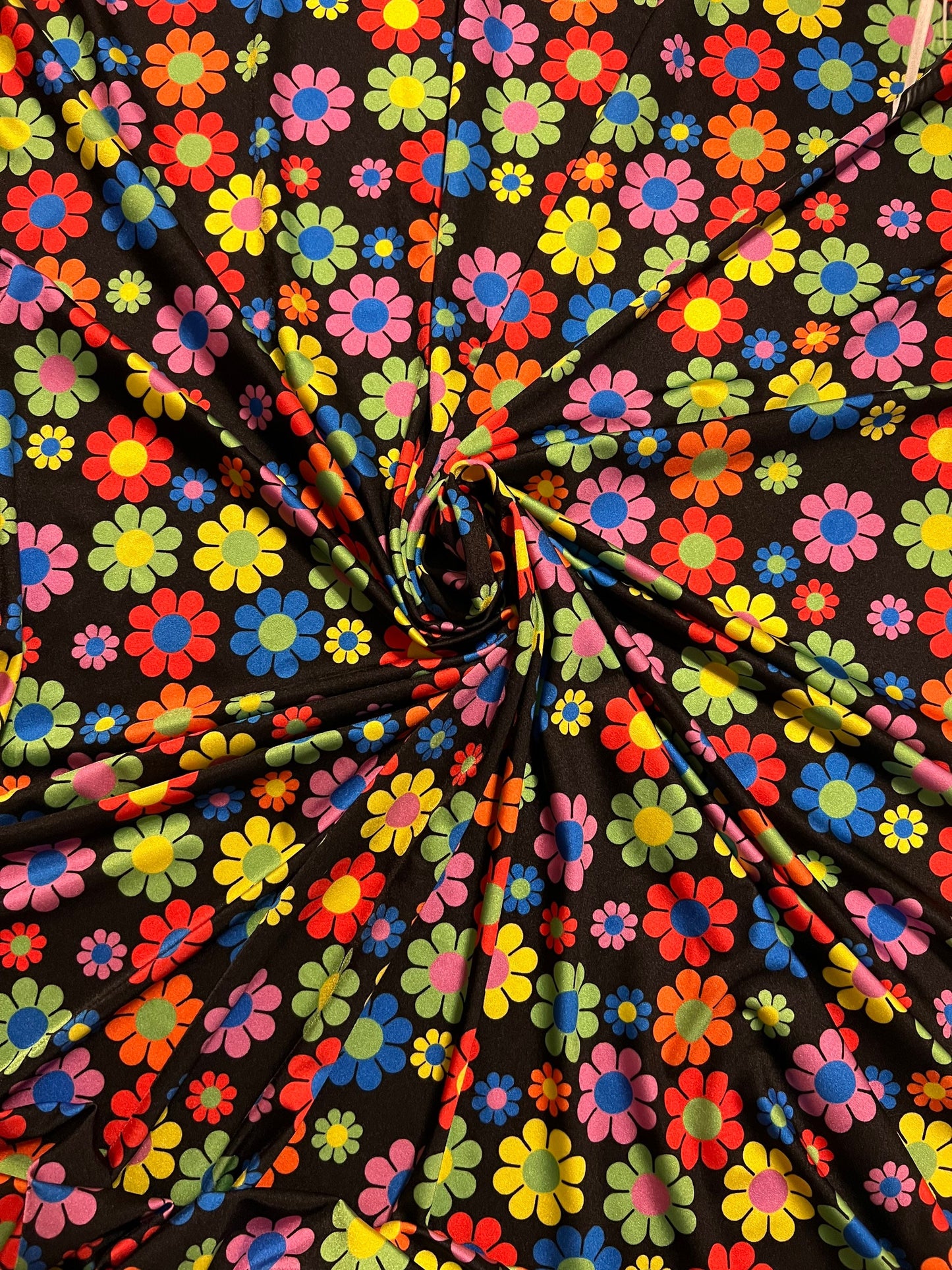 New daisy flower design Black/Multicolor print on great quality of nylon spandex 4-way stretch 58/60” Sold by the YD.